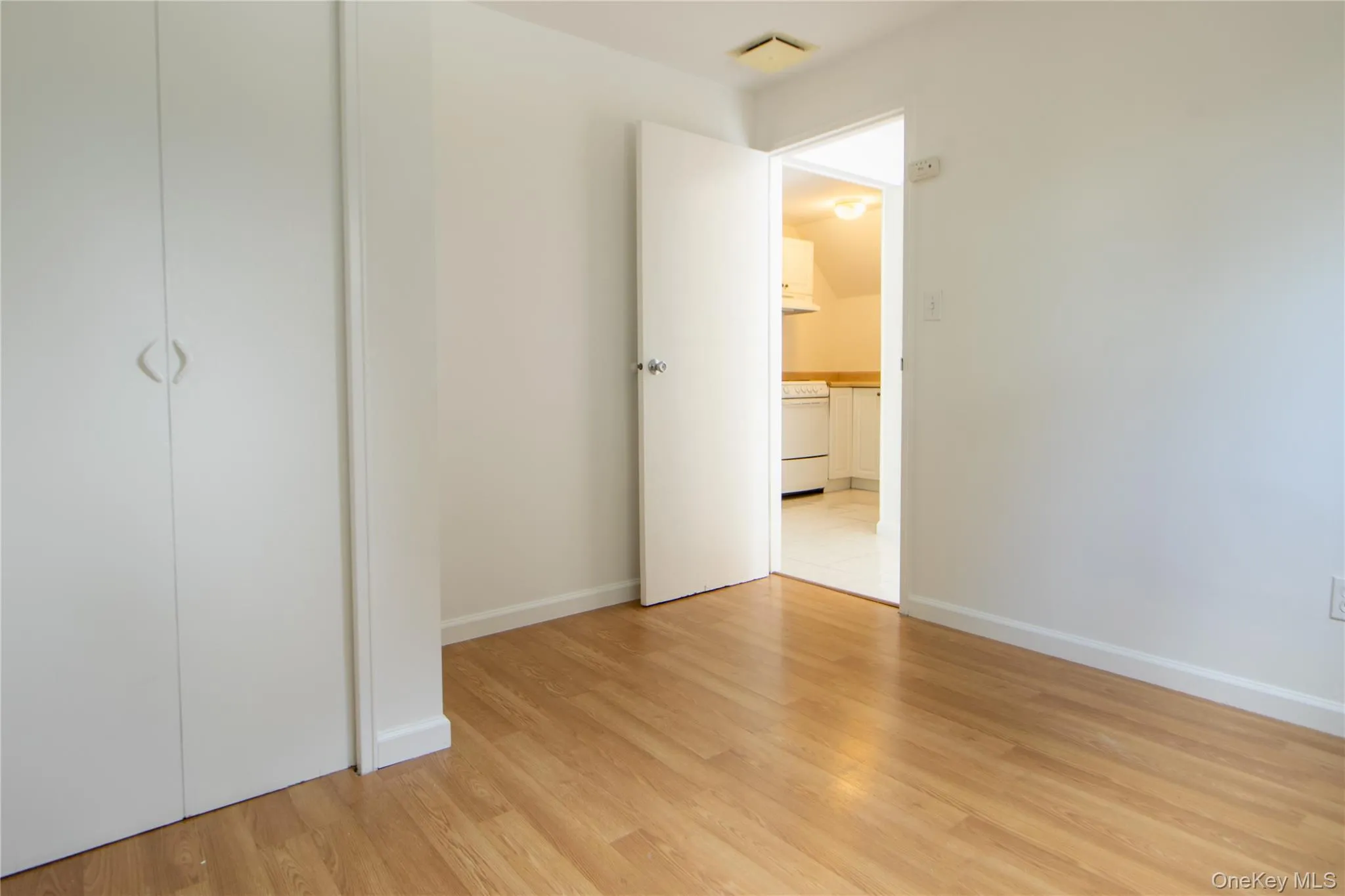 Unfurnished bedroom with light flooring and baseboards Unfurnished bedroom with light flooring and baseboards