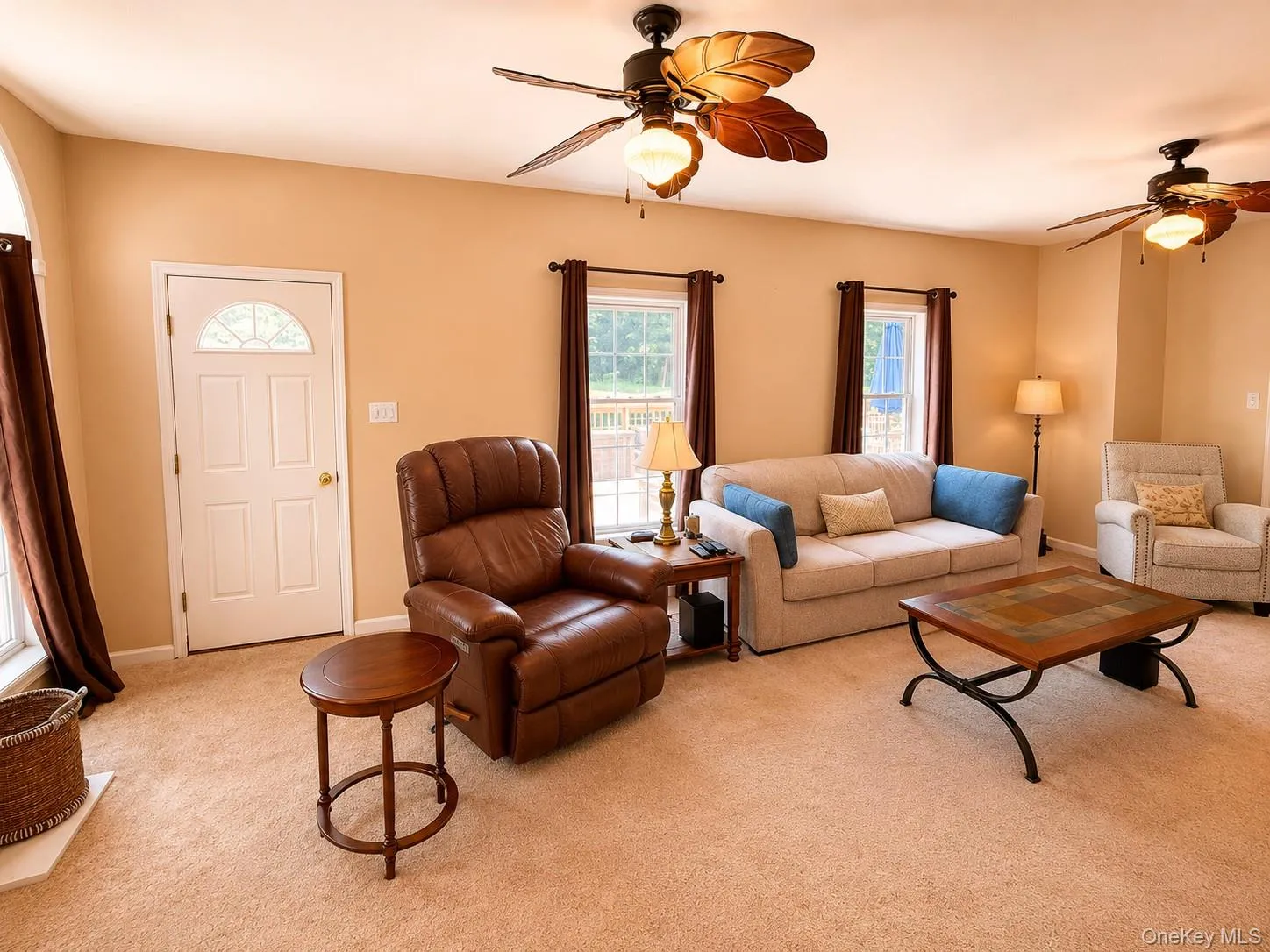 Expansive living room with a door leading the a large deck Expansive living room with a door leading the a large deck