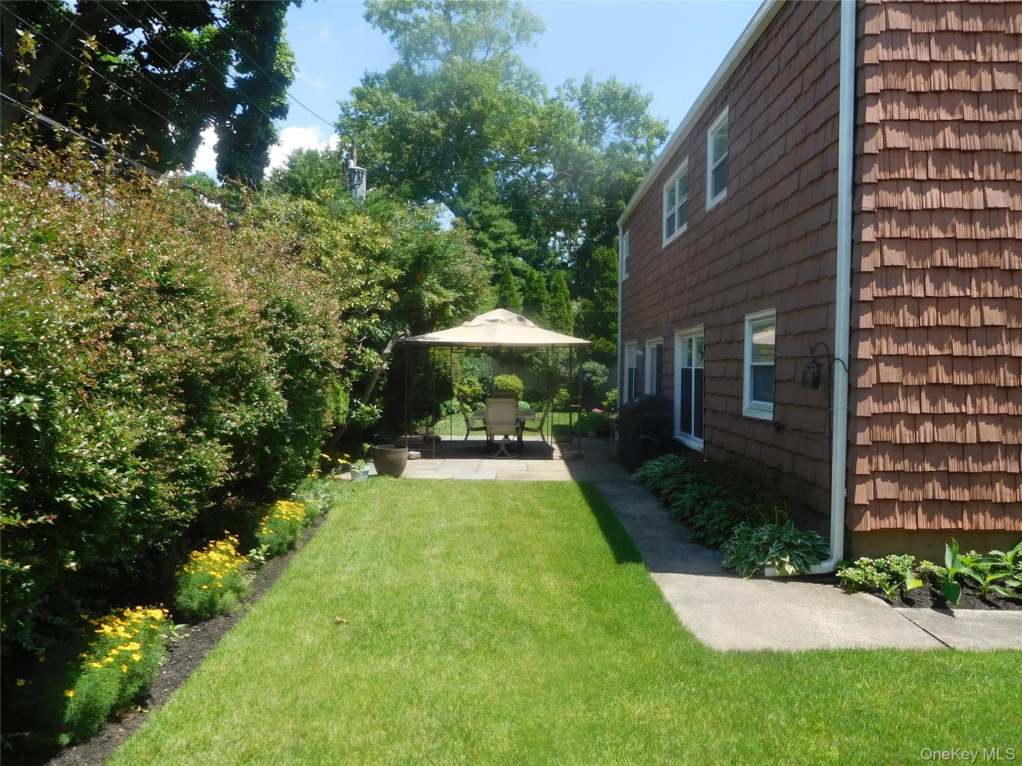 Manicured lawn with a dedicated patio space Manicured lawn with a dedicated patio space