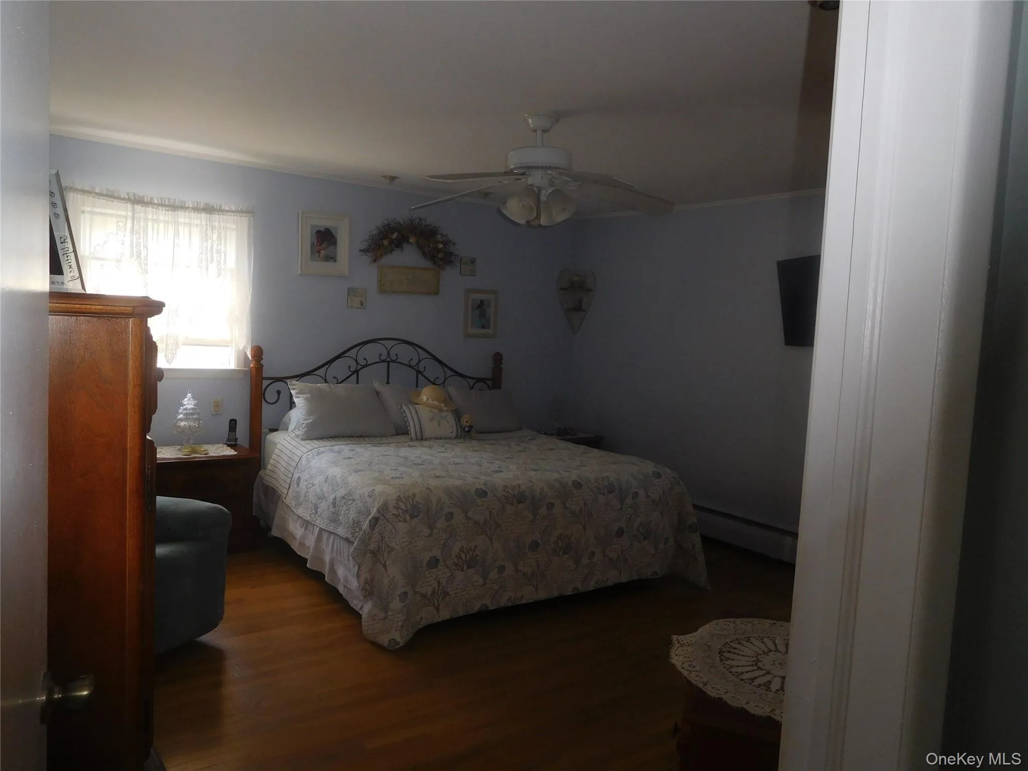 Wood-finish flooring with a ceiling fan overhead Wood-finish flooring with a ceiling fan overhead