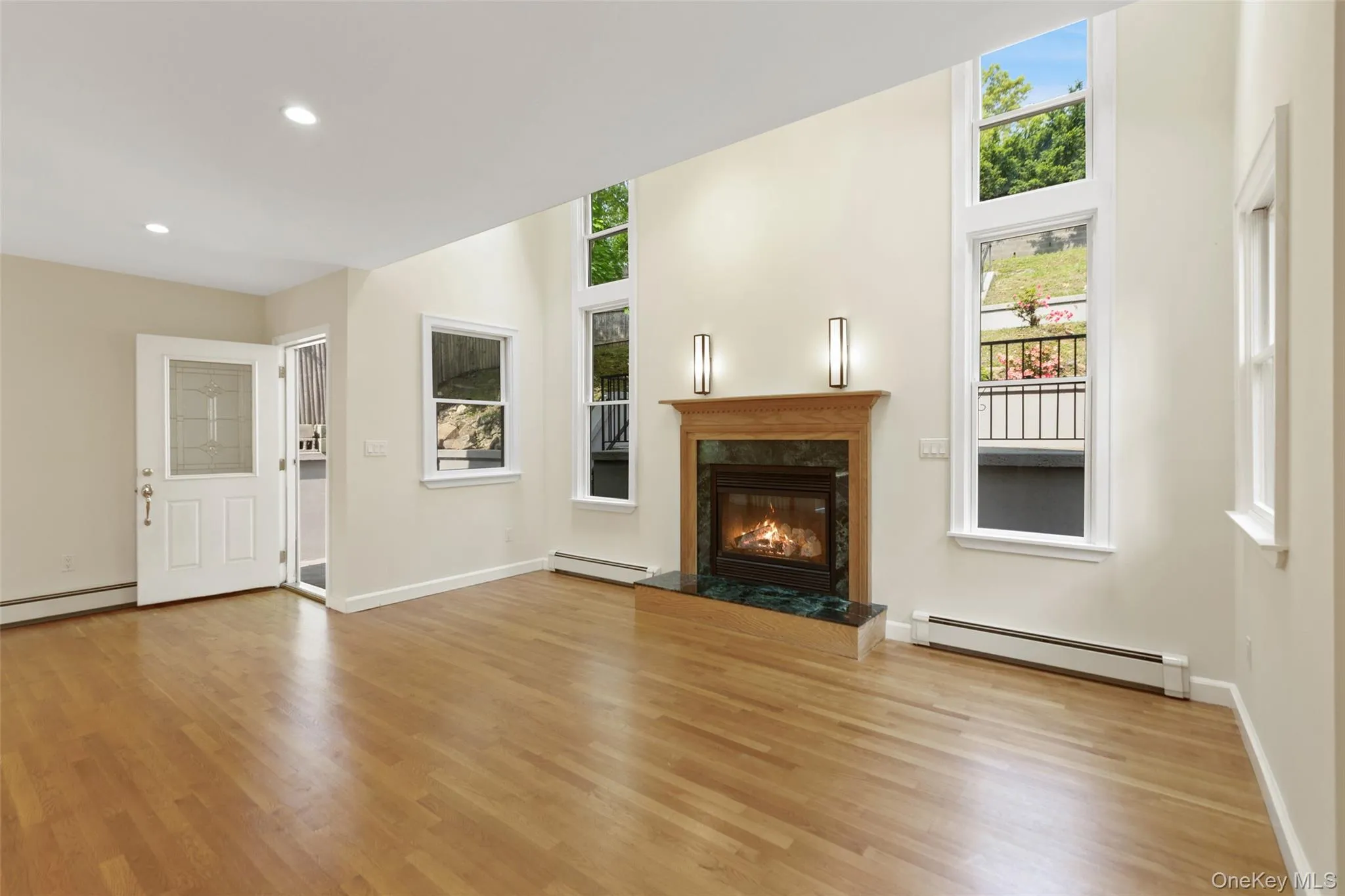 Living room with plenty of natural light and door to the back yard Living room with plenty of natural light and door to the back yard