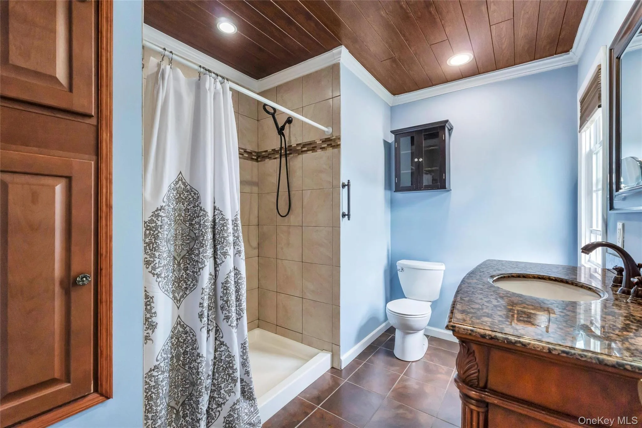 Bathroom featuring a wood-panel ceiling, recessed lighting, and ceramic tile flooring Bathroom featuring a wood-panel ceiling, recessed lighting, and ceramic tile flooring