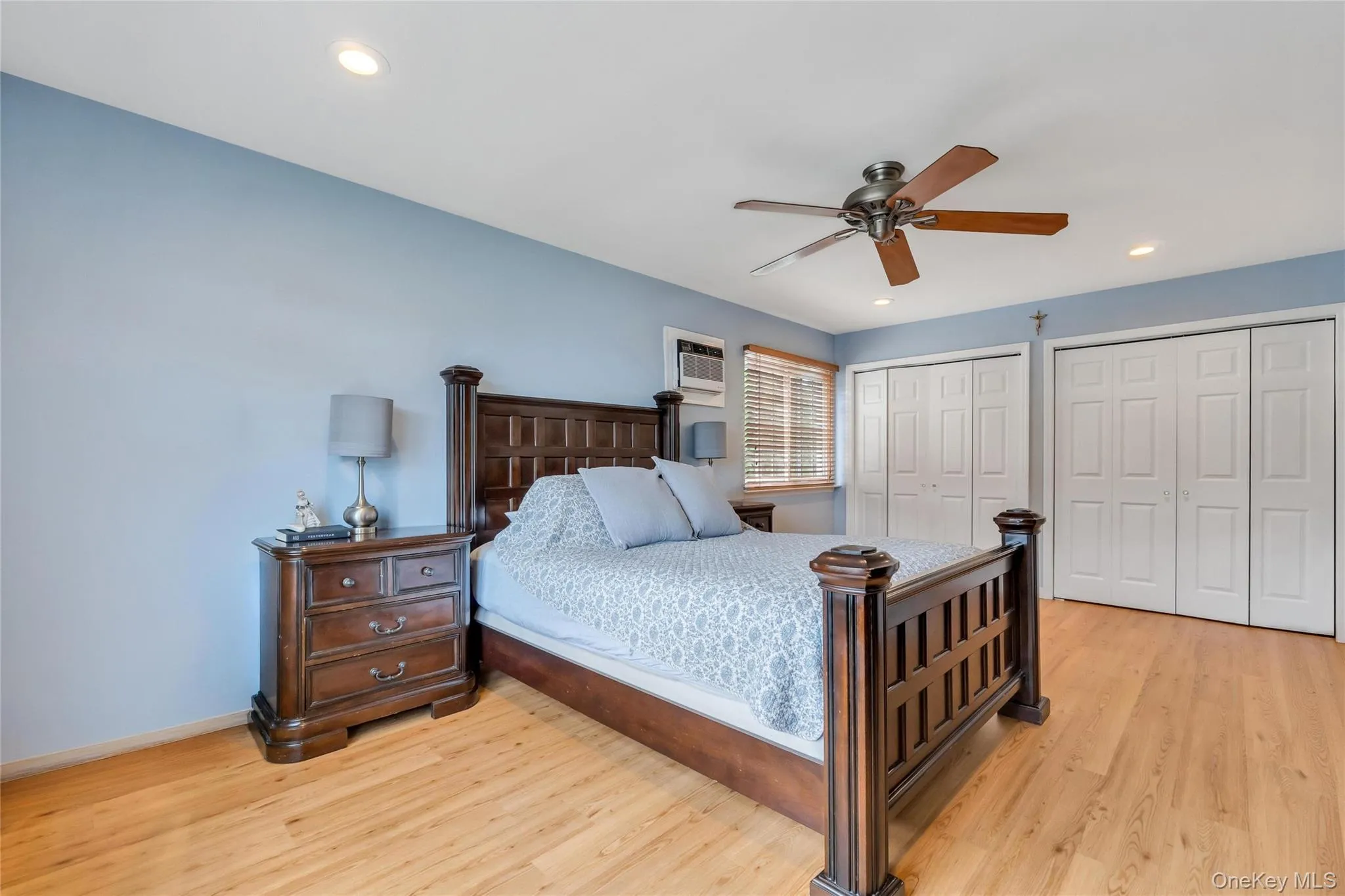 Bedroom featuring wood-finish flooring, recessed lighting, and a ceiling fan Bedroom featuring wood-finish flooring, recessed lighting, and a ceiling fan