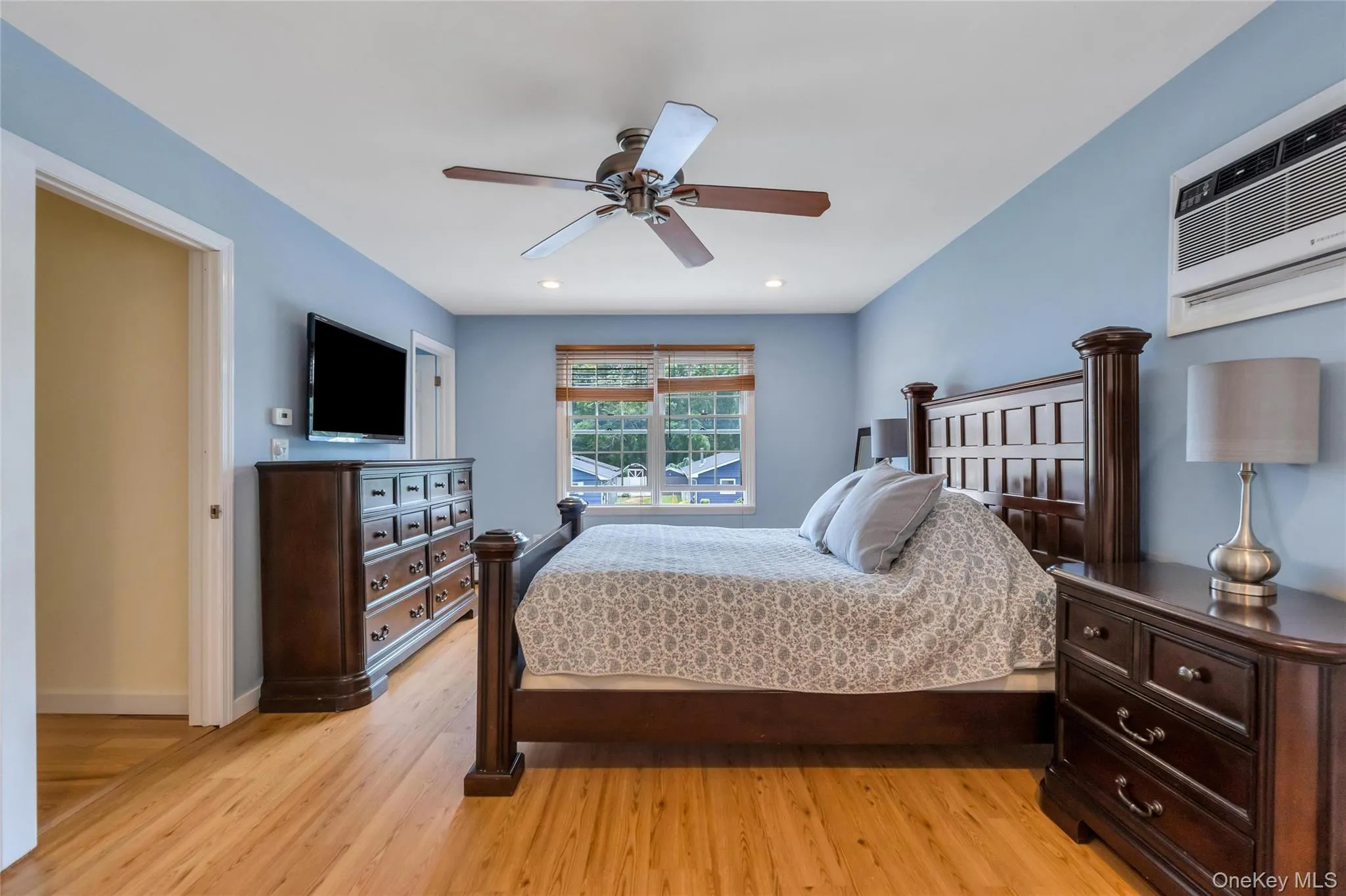 Spacious room featuring wood-finish flooring, recessed lighting, and a ceiling fan Spacious room featuring wood-finish flooring, recessed lighting, and a ceiling fan