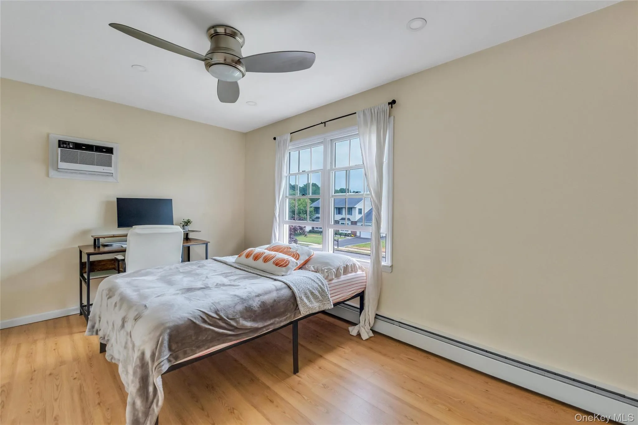 Bedroom featuring wood-finish flooring, recessed lighting, and a ceiling fan with integrated light Bedroom featuring wood-finish flooring, recessed lighting, and a ceiling fan with integrated light