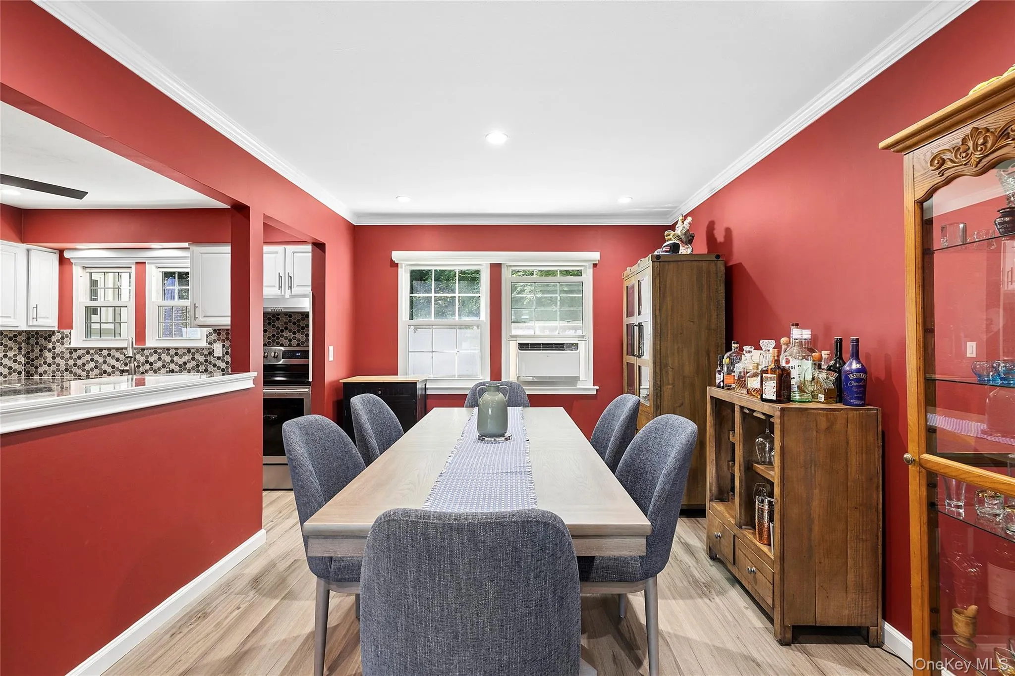 Dining area with wood-finish flooring and crown molding Dining area with wood-finish flooring and crown molding