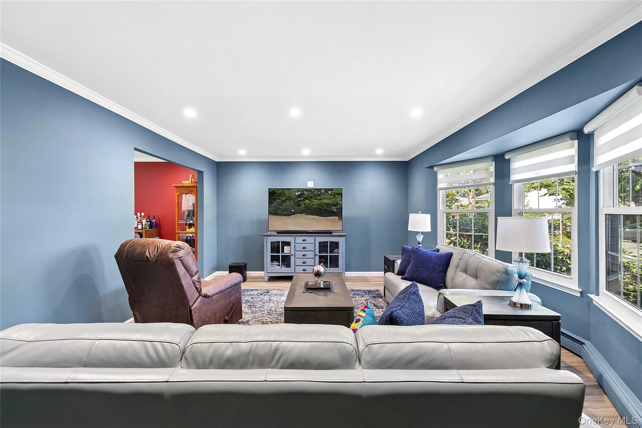 Recessed lighting illuminates this room, featuring light blue walls and white crown molding Recessed lighting illuminates this room, featuring light blue walls and white crown molding