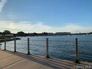 Waterfront setting with a concrete walkway and cable railing Waterfront setting with a concrete walkway and cable railing