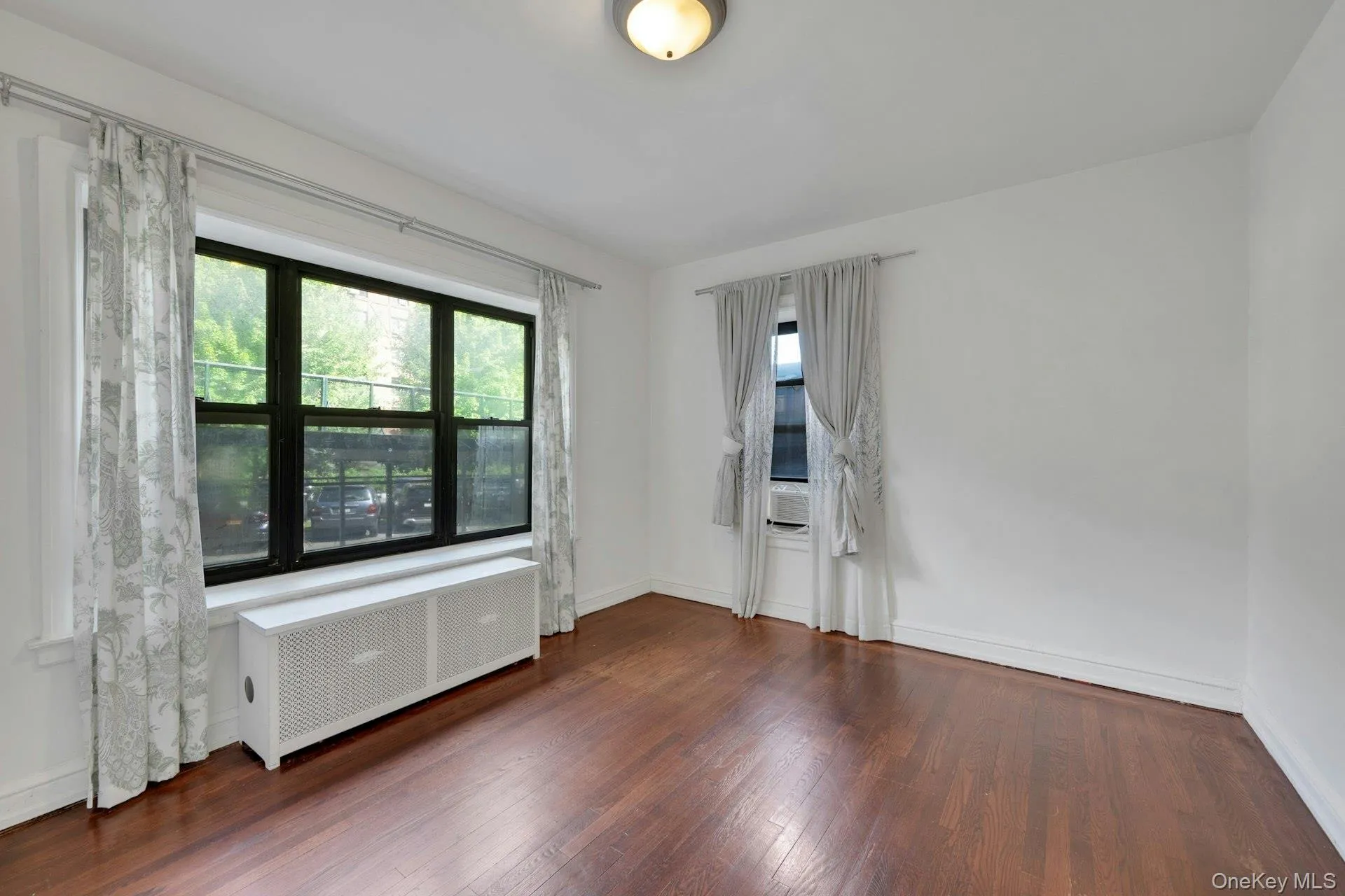 Expansive wood-finish flooring complements white walls Expansive wood-finish flooring complements white walls