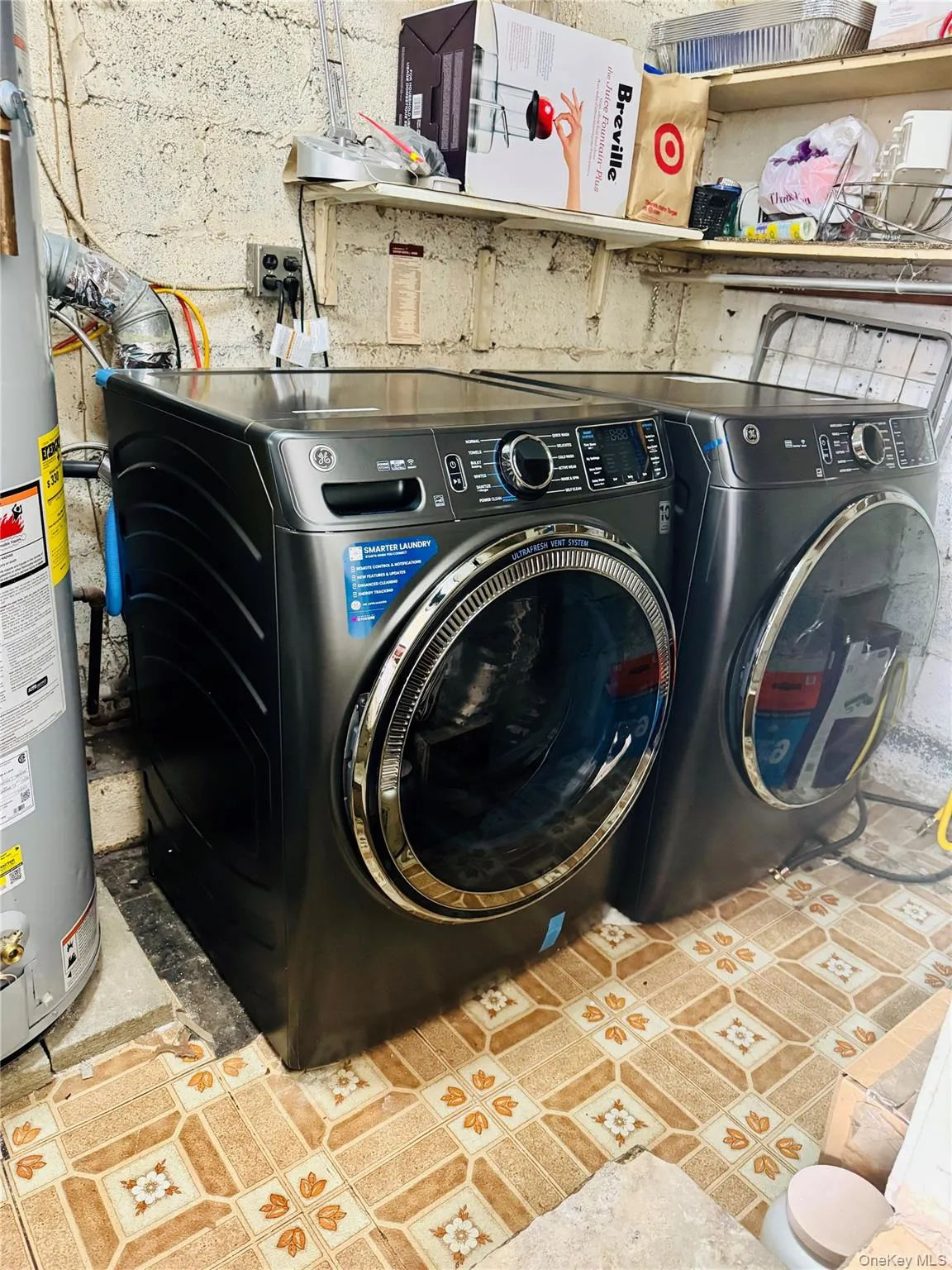 Laundry room with electric water heater and washer and dryer Laundry room with electric water heater and washer and dryer