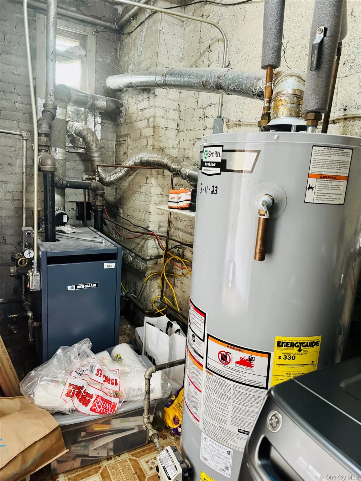 Utilities featuring water heater and a heating unit Utilities featuring water heater and a heating unit