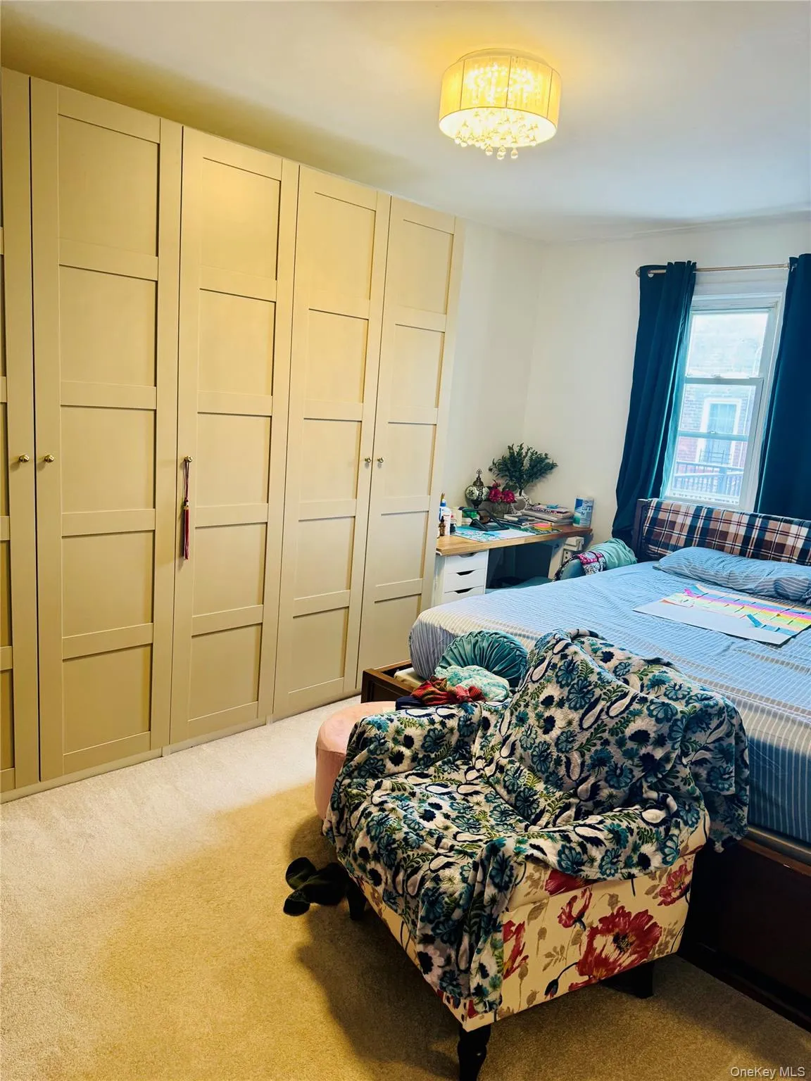 Bedroom with carpet floors and a chandelier Bedroom with carpet floors and a chandelier