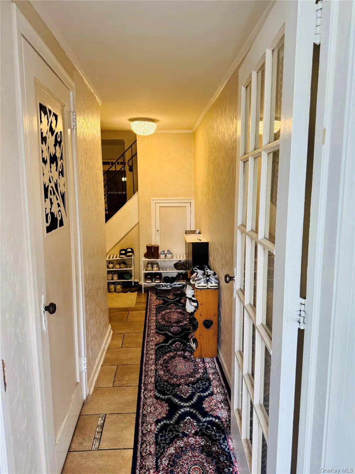 Hall featuring crown molding and stairs Hall featuring crown molding and stairs