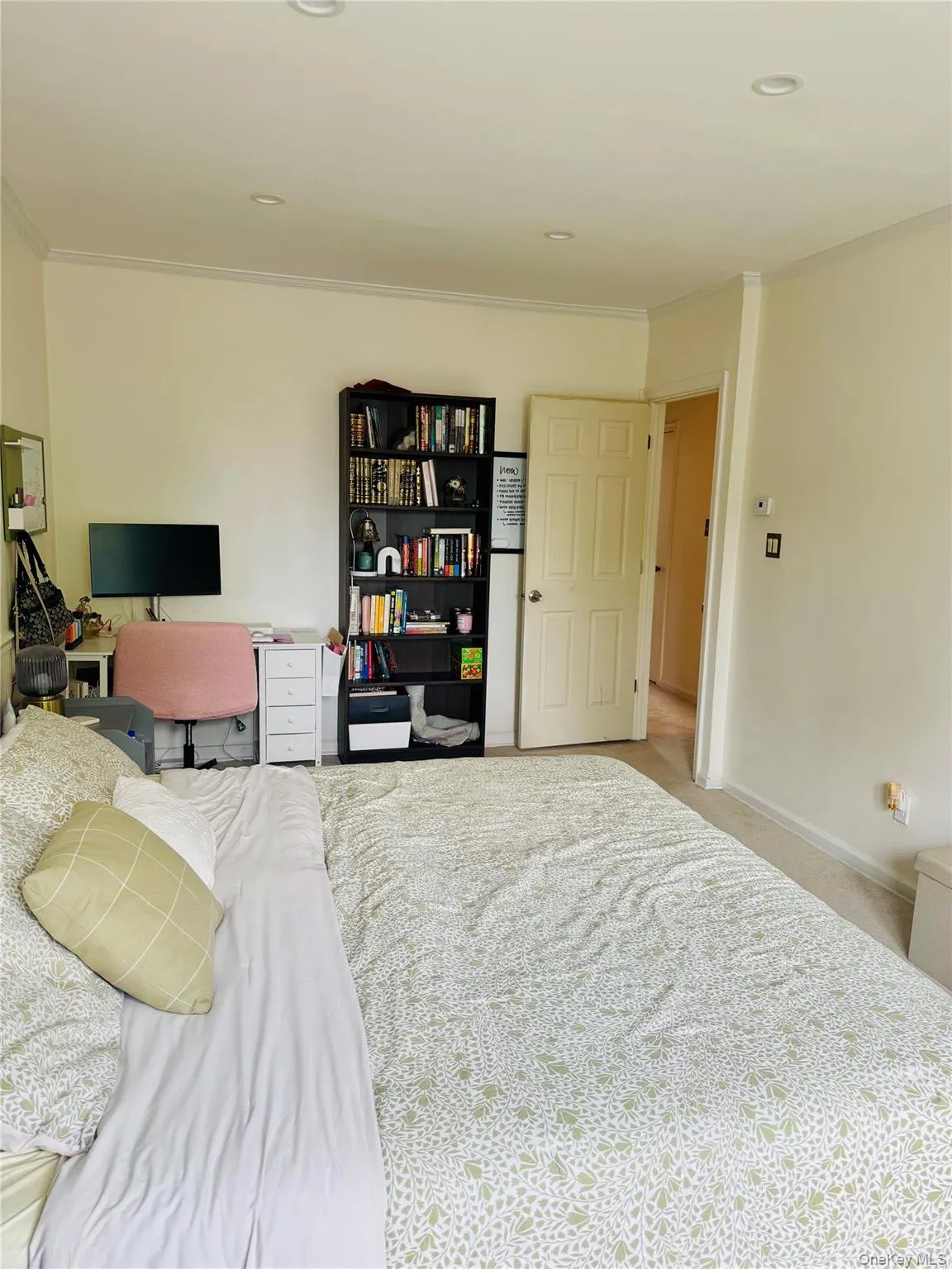 Carpeted bedroom with ornamental molding and baseboards Carpeted bedroom with ornamental molding and baseboards