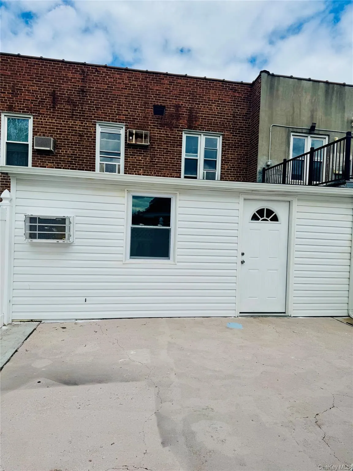 Rear view of property featuring a patio and brick siding Rear view of property featuring a patio and brick siding