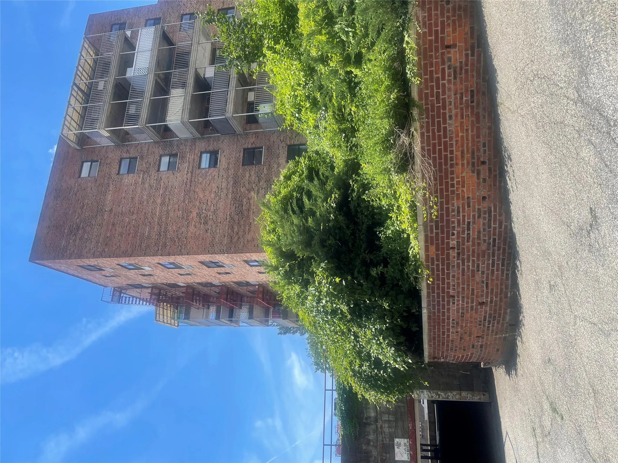 Brick exterior building featuring multiple levels of balconies Brick exterior building featuring multiple levels of balconies