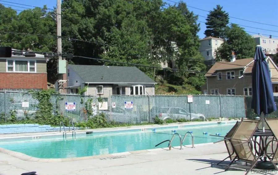 In-ground swimming pool with concrete surround In-ground swimming pool with concrete surround