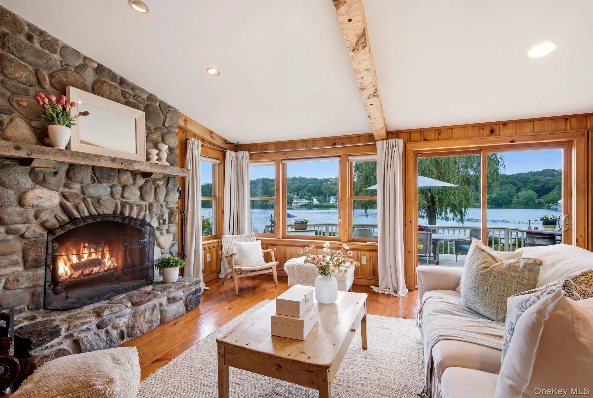 Family Room with second wood burning fireplace, ceiling with wood beams and paneled walls. Family Room with second wood burning fireplace, ceiling with wood beams and paneled walls.