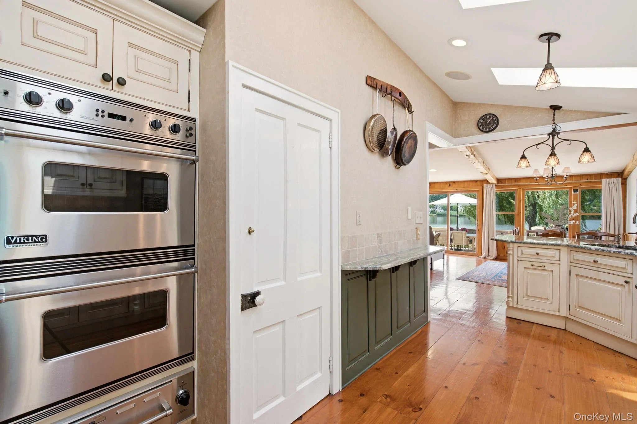 Double Viking wall ovens with warming drawer. Door access to the basement. Double Viking wall ovens with warming drawer. Door access to the basement.
