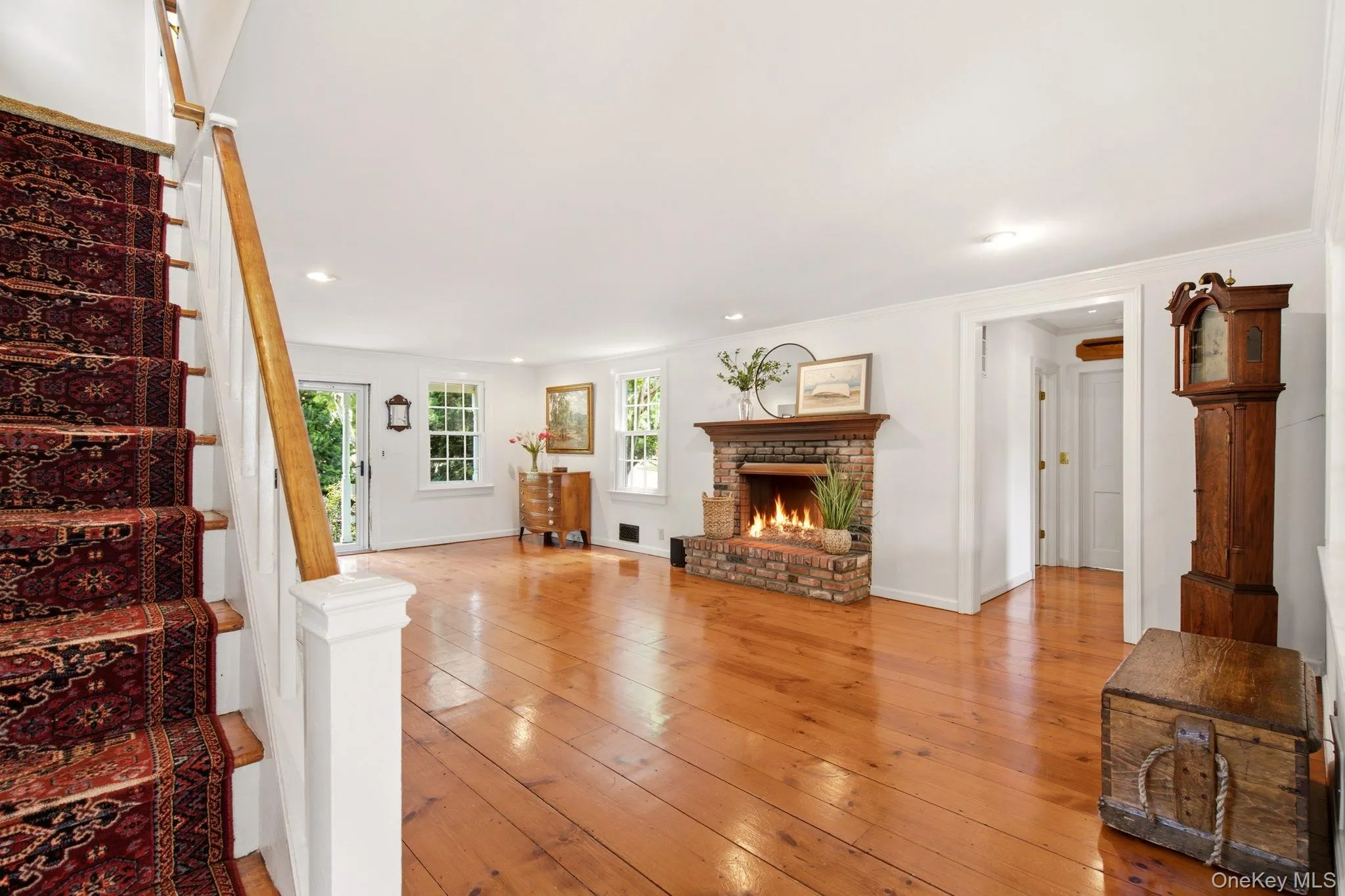 Spacious Living Room shows hallway to first floor primary suite. Spacious Living Room shows hallway to first floor primary suite.