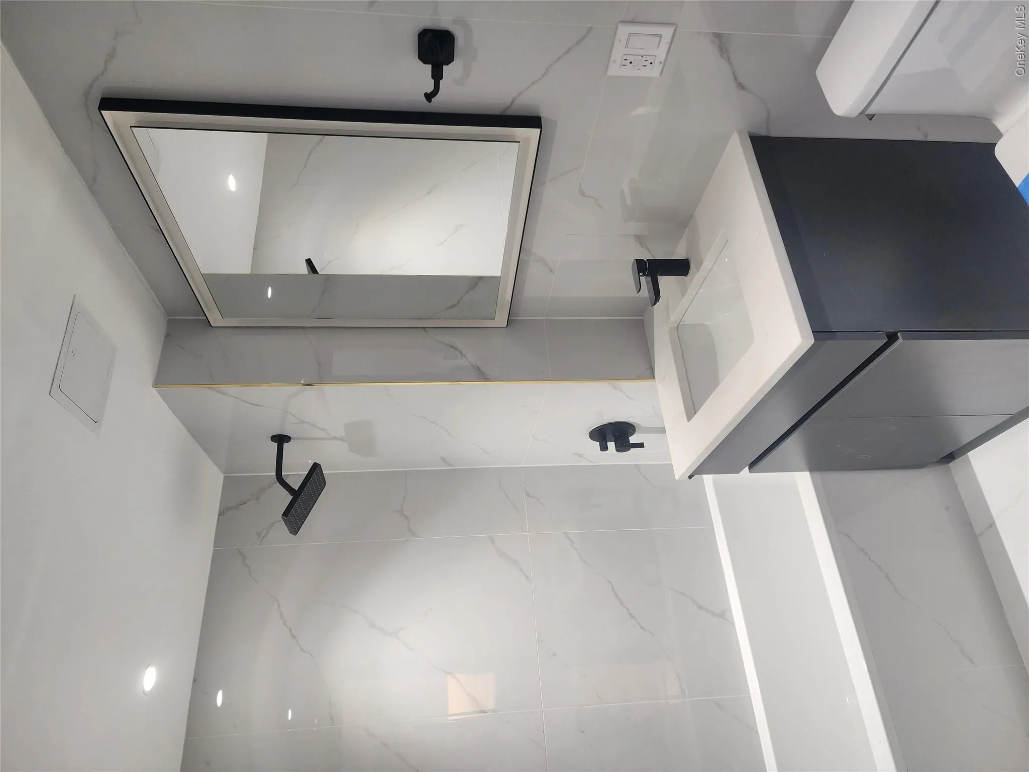 Bathroom featuring a built-in tub with matte black fixtures Bathroom featuring a built-in tub with matte black fixtures