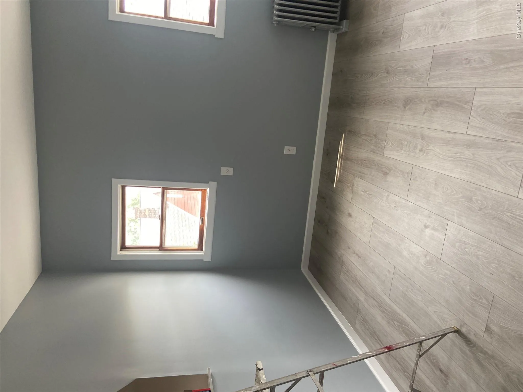 Light gray wood-finish flooring complements the neutral wall color Light gray wood-finish flooring complements the neutral wall color