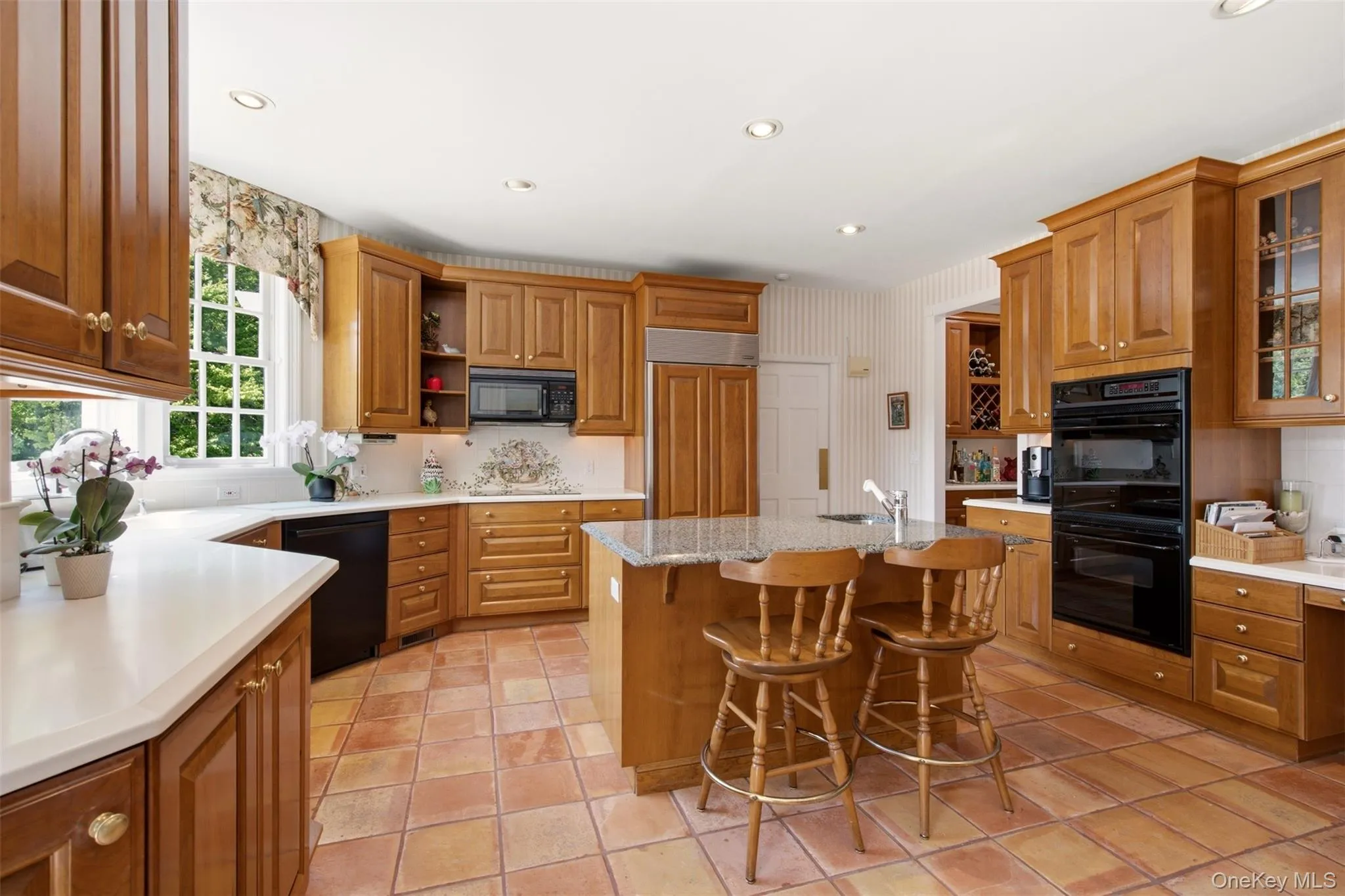Wood Mode Cabinetry with a granite countertop on the island Wood Mode Cabinetry with a granite countertop on the island