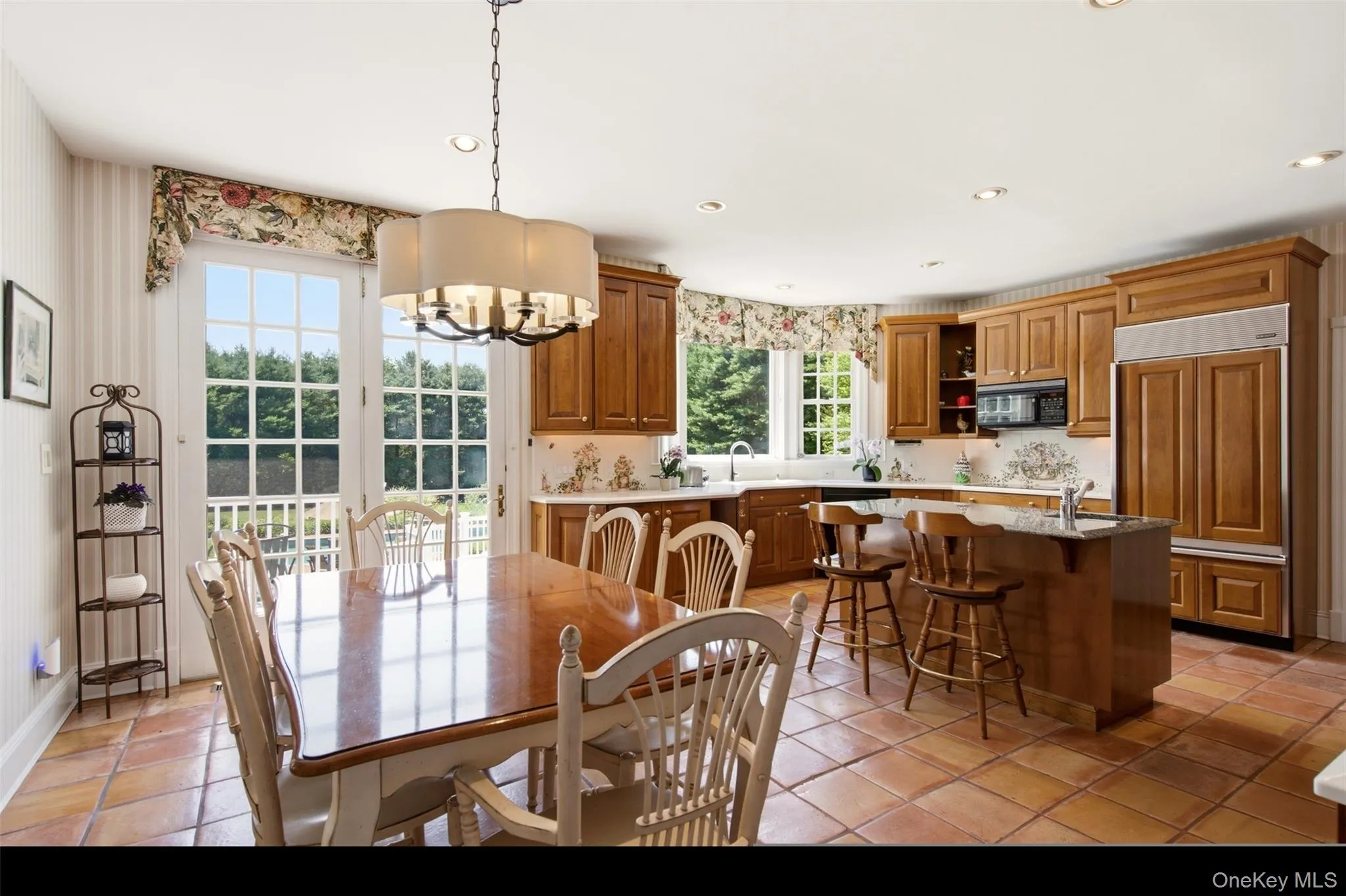 Country kitchen with eat in breakfast table and French doors leading to the deck. Country kitchen with eat in breakfast table and French doors leading to the deck.