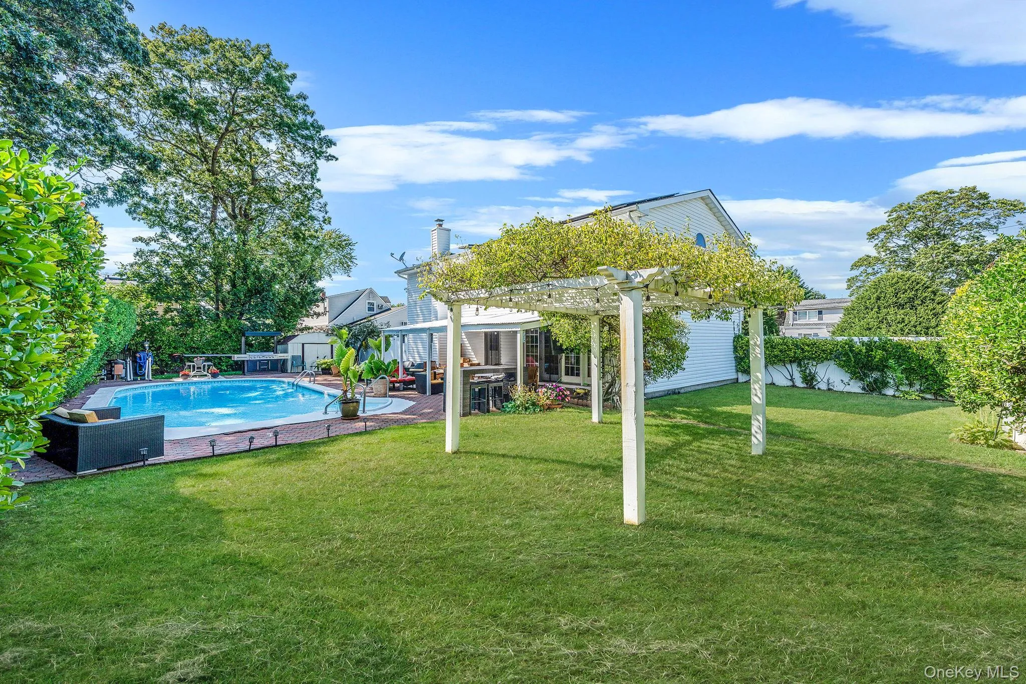 View of pool featuring a pergola and a patio View of pool featuring a pergola and a patio