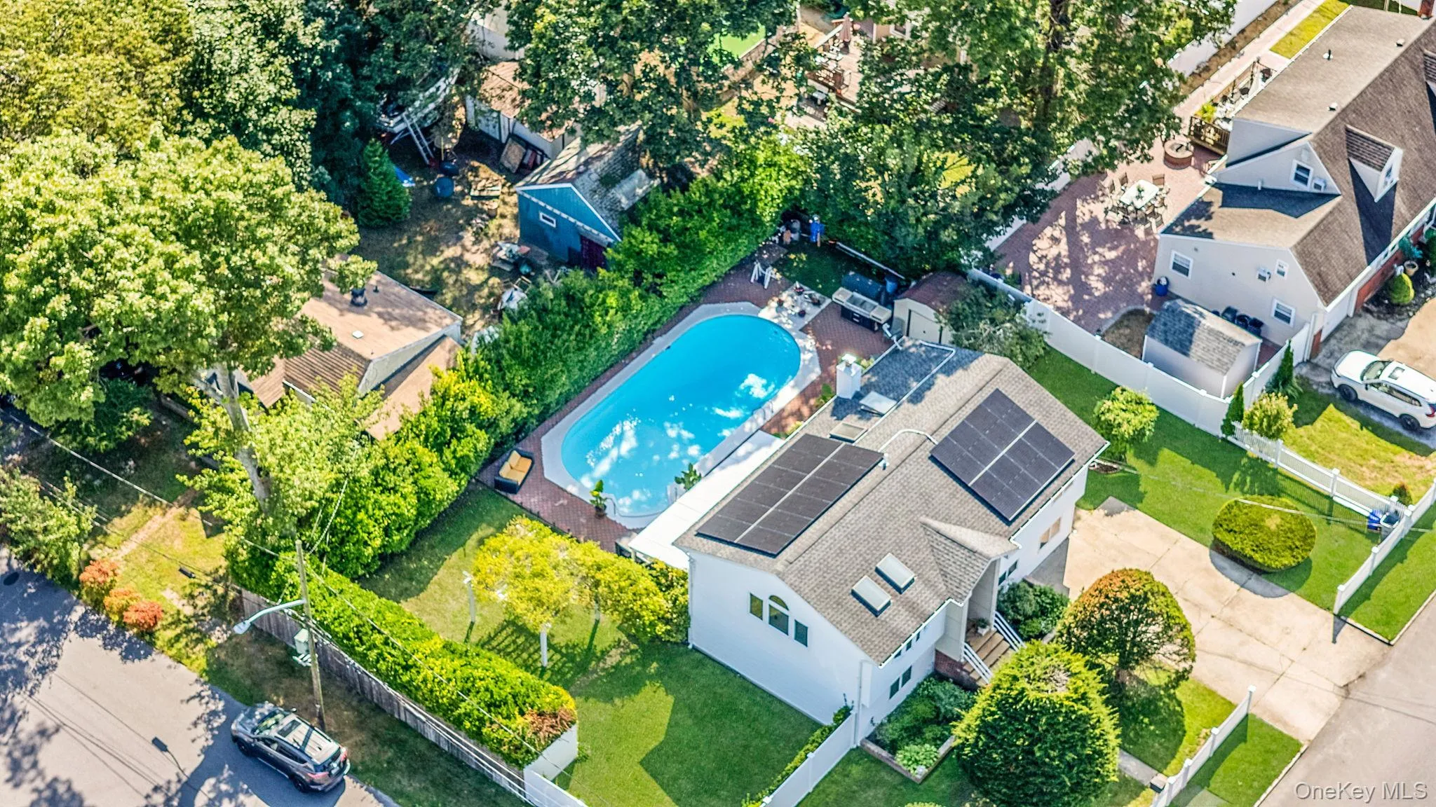 Aerial view of property and surrounding area featuring a pool Aerial view of property and surrounding area featuring a pool