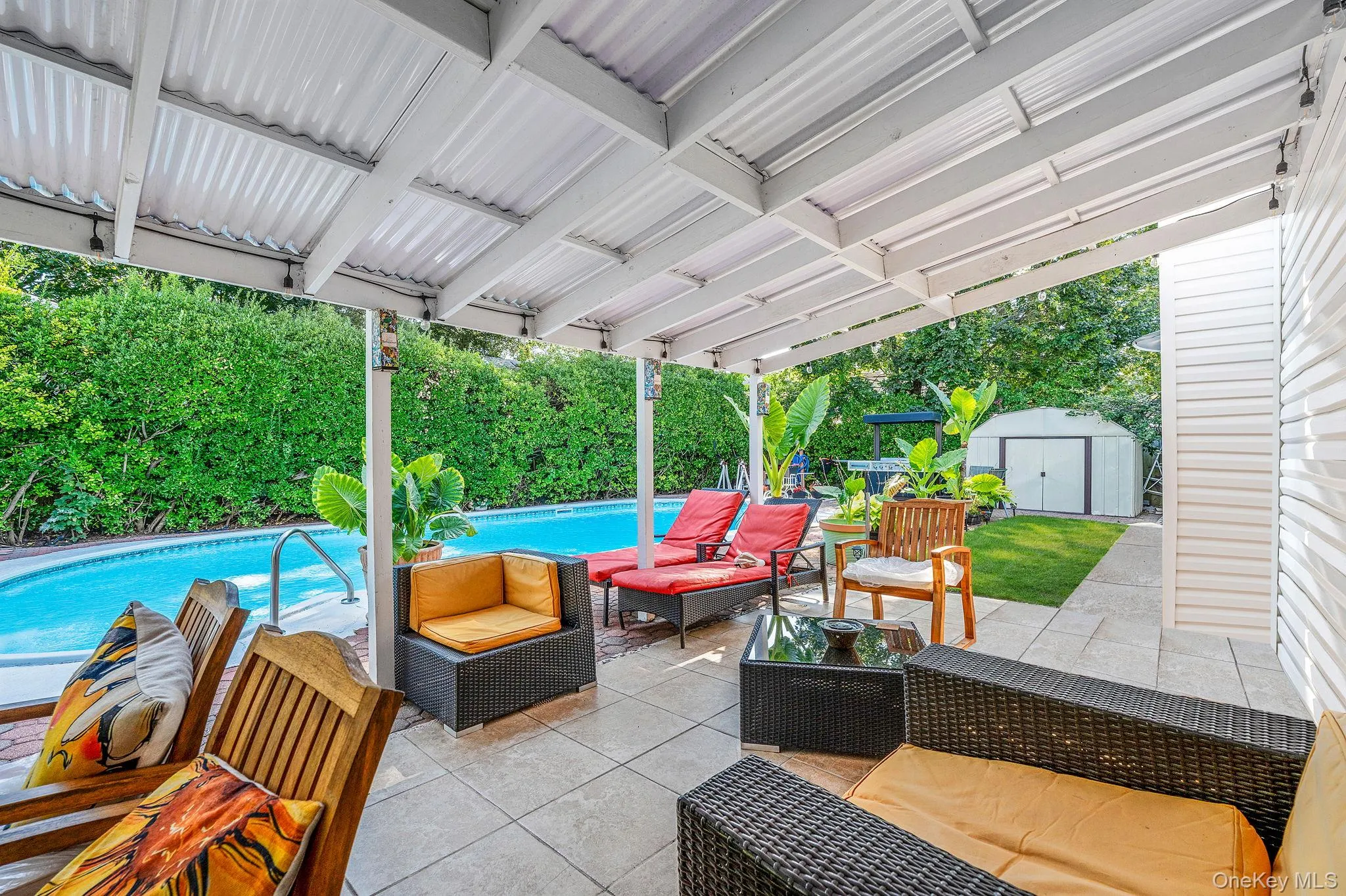 Fenced backyard featuring outdoor lounge area, a patio area, a storage shed, and view of wooded area Fenced backyard featuring outdoor lounge area, a patio area, a storage shed, and view of wooded area