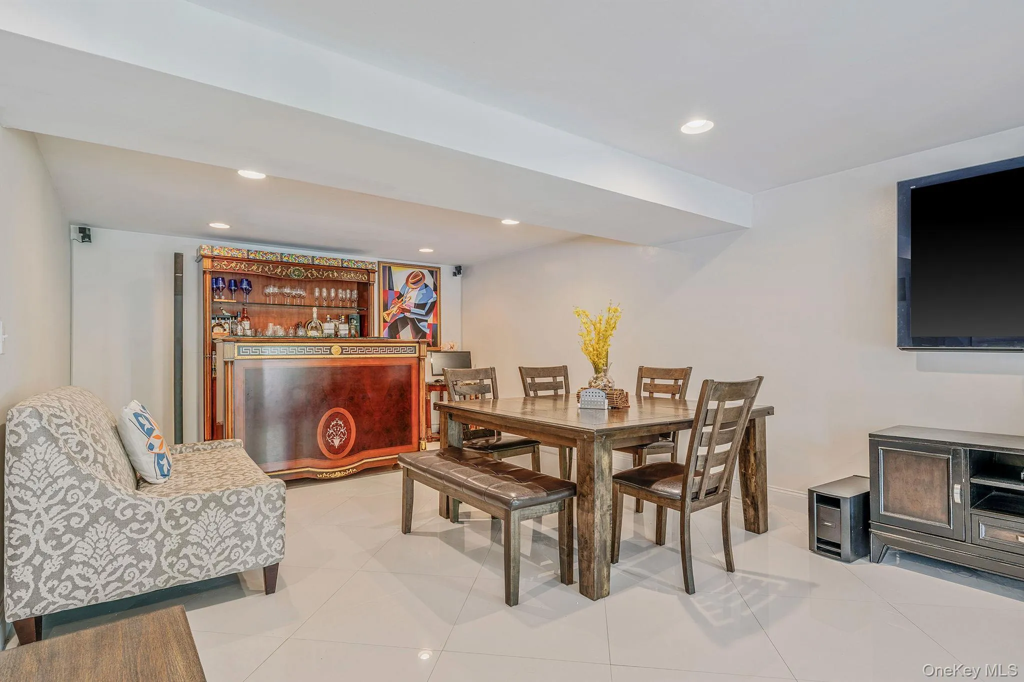 Dining area with recessed lighting and light tile patterned floors Dining area with recessed lighting and light tile patterned floors