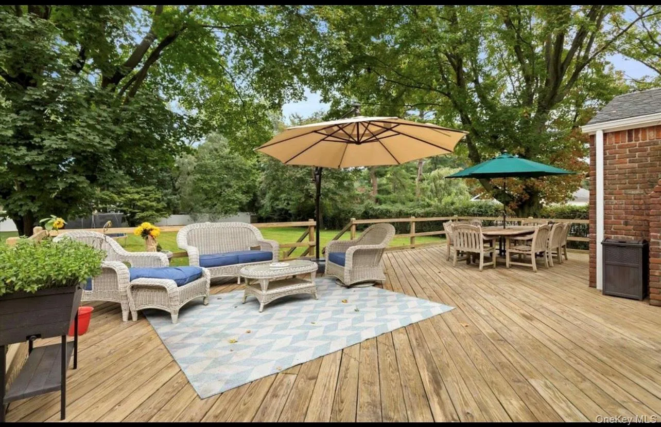 Deck with outdoor dining area, an outdoor living space, and view of wooded area Deck with outdoor dining area, an outdoor living space, and view of wooded area