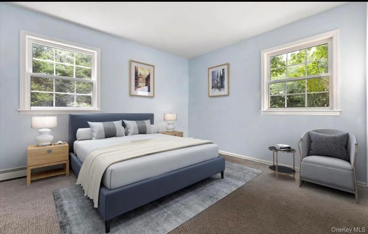 Carpeted bedroom featuring multiple windows Carpeted bedroom featuring multiple windows