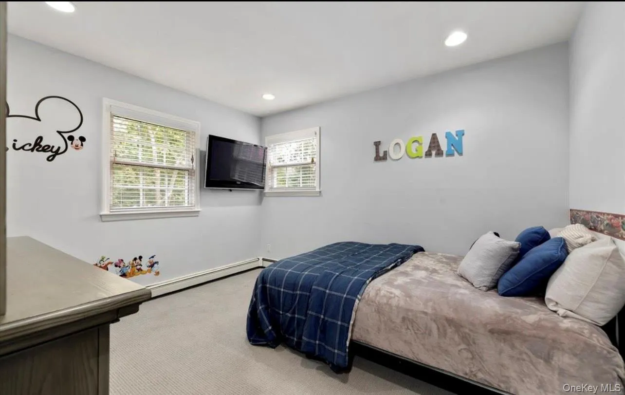 Bedroom featuring carpet, baseboard heating, and recessed lighting Bedroom featuring carpet, baseboard heating, and recessed lighting