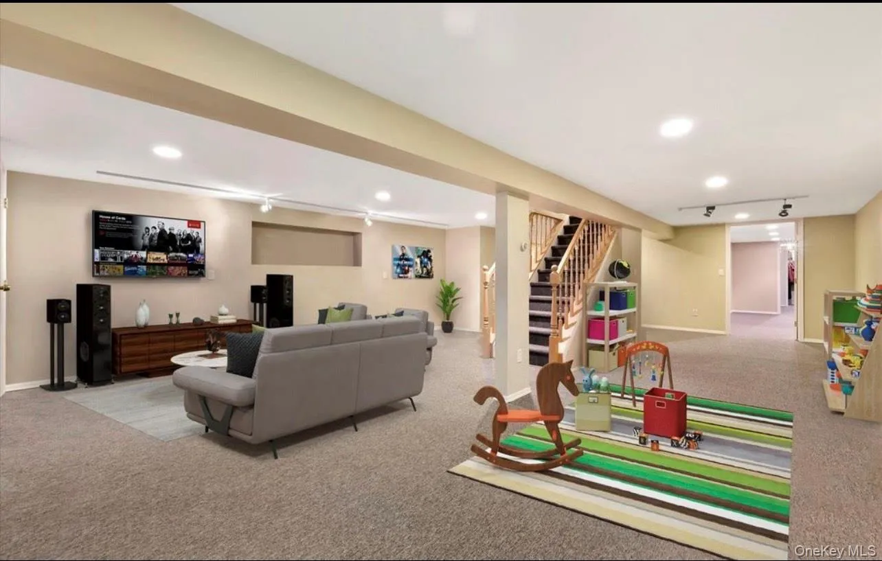 Living area featuring carpet flooring, stairway, recessed lighting, and rail lighting Living area featuring carpet flooring, stairway, recessed lighting, and rail lighting