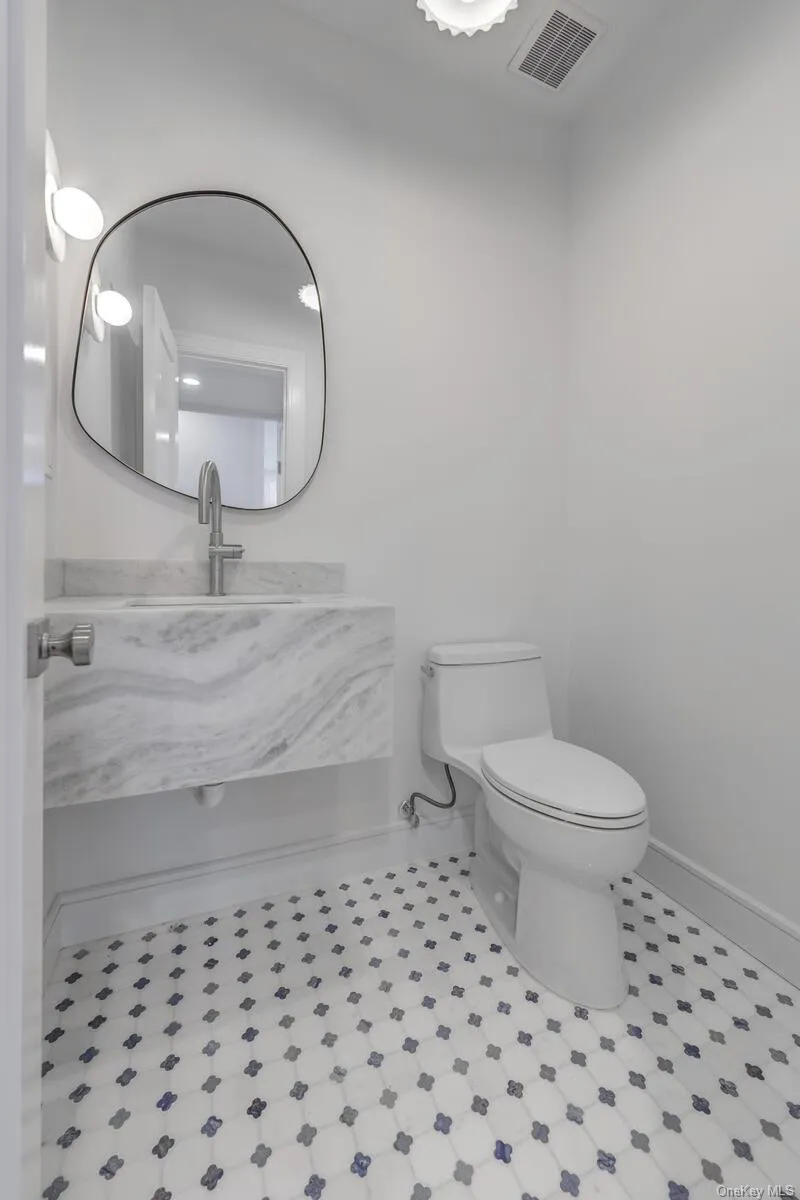 Bathroom with toilet, baseboards, visible vents, and vanity Bathroom with toilet, baseboards, visible vents, and vanity