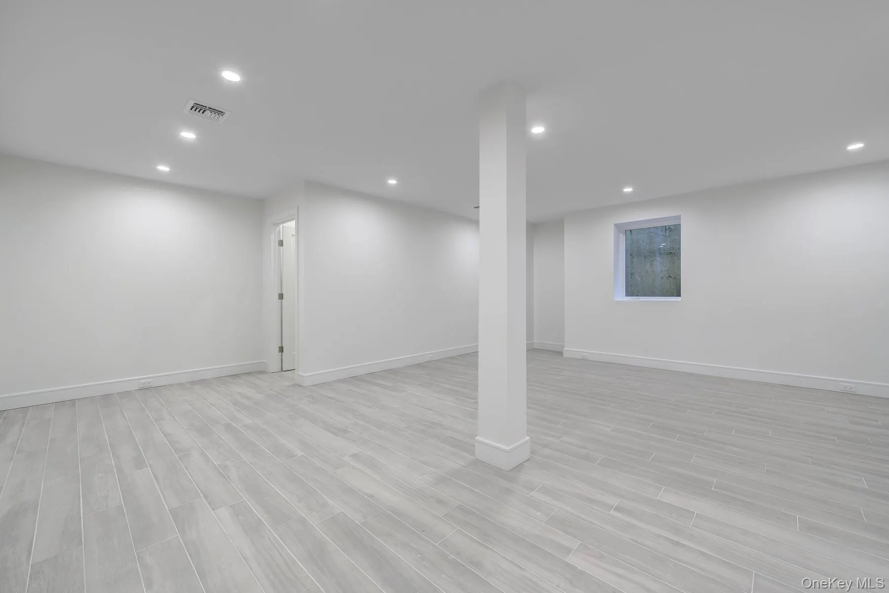 Finished basement featuring visible vents and recessed lighting Finished basement featuring visible vents and recessed lighting