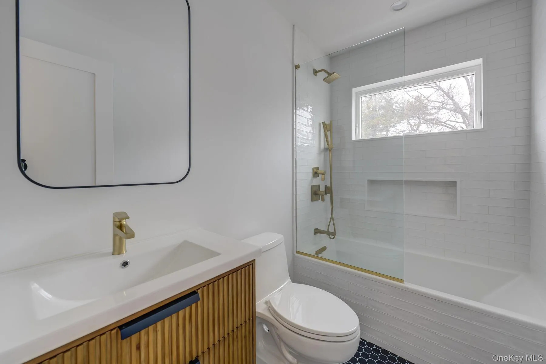 Bathroom with toilet, tiled shower / bath, and vanity Bathroom with toilet, tiled shower / bath, and vanity