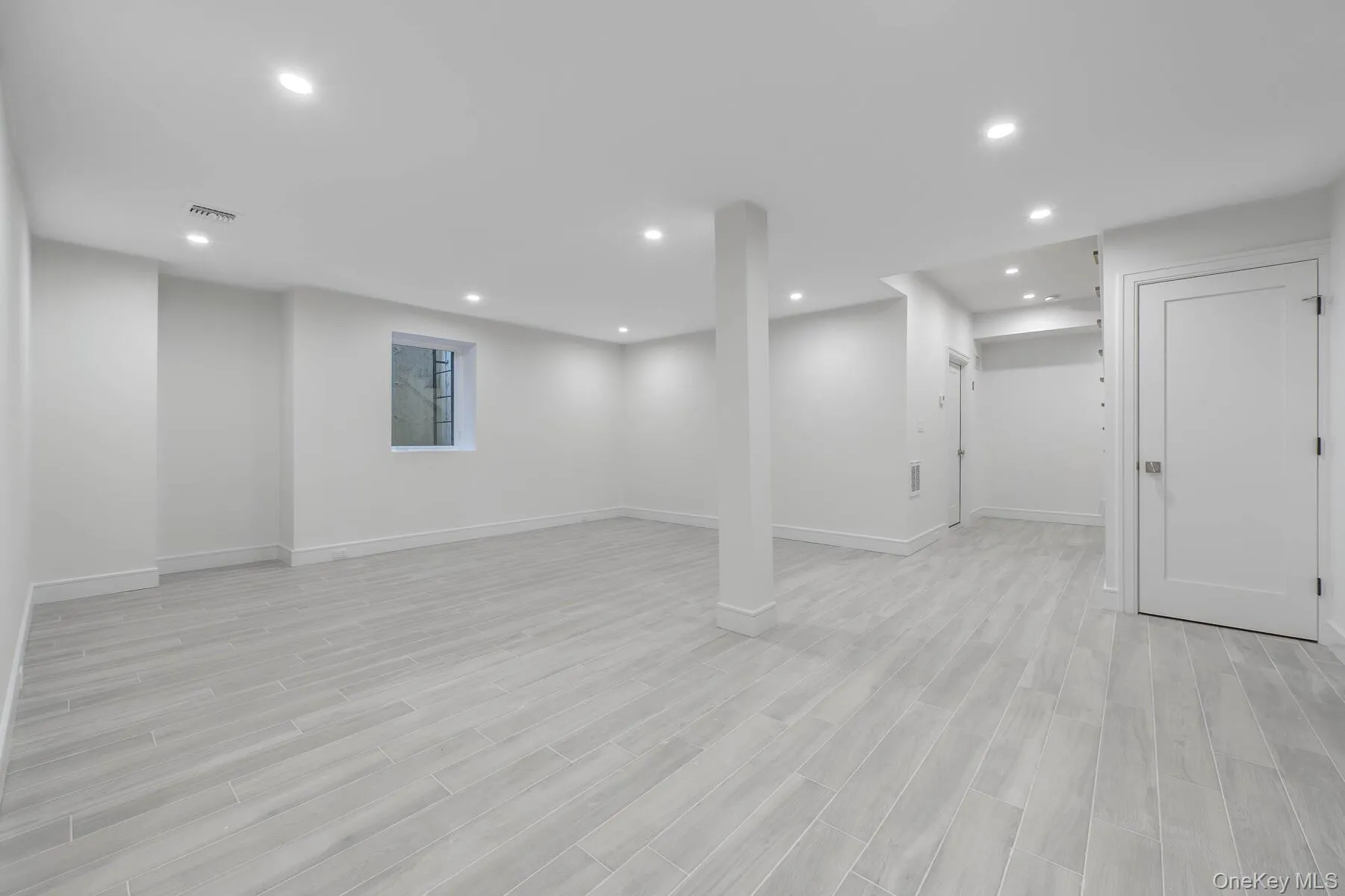 Finished basement with baseboards, light wood finished floors, and recessed lighting Finished basement with baseboards, light wood finished floors, and recessed lighting