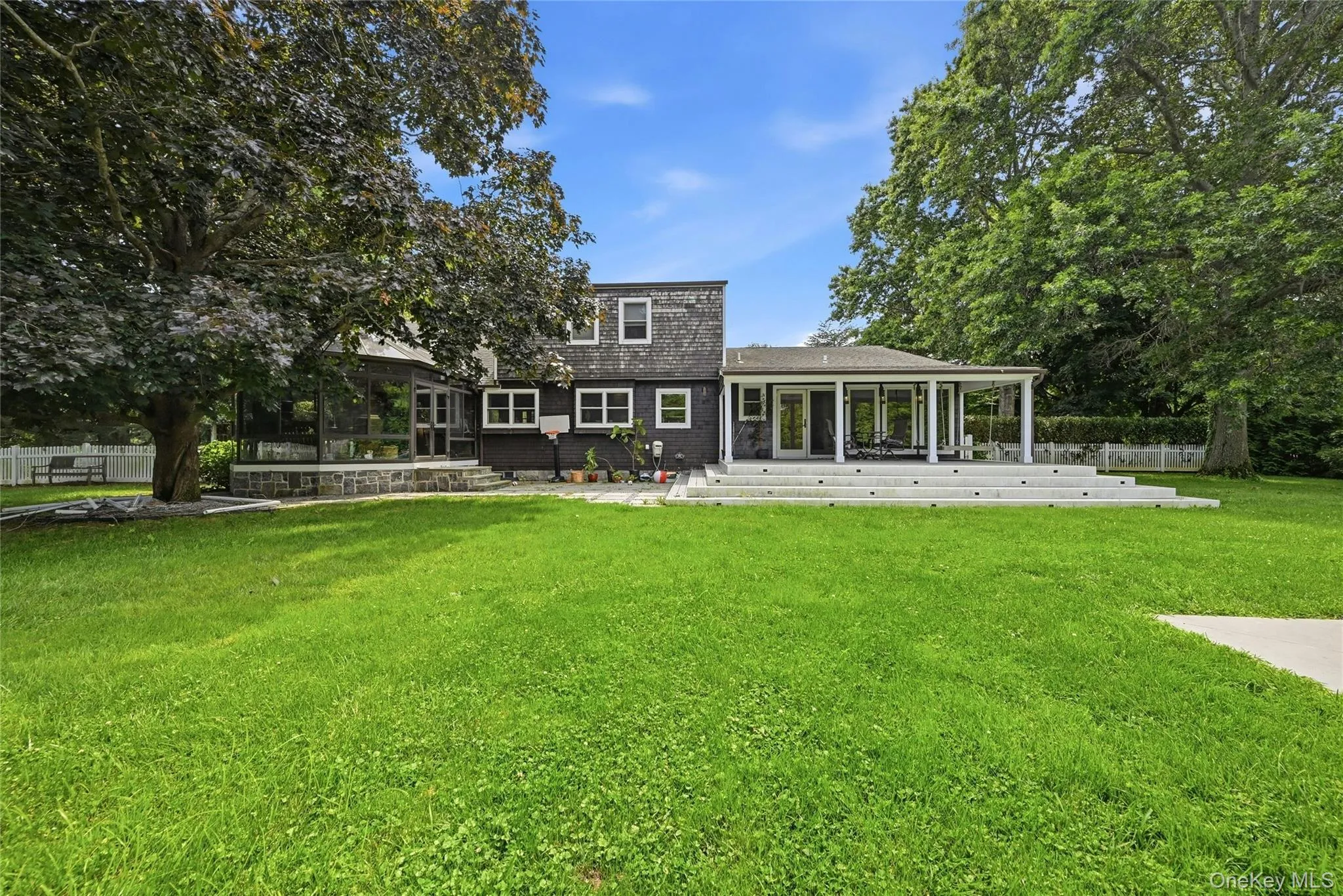 Spacious backyard featuring a substantial lawn and mature trees Spacious backyard featuring a substantial lawn and mature trees