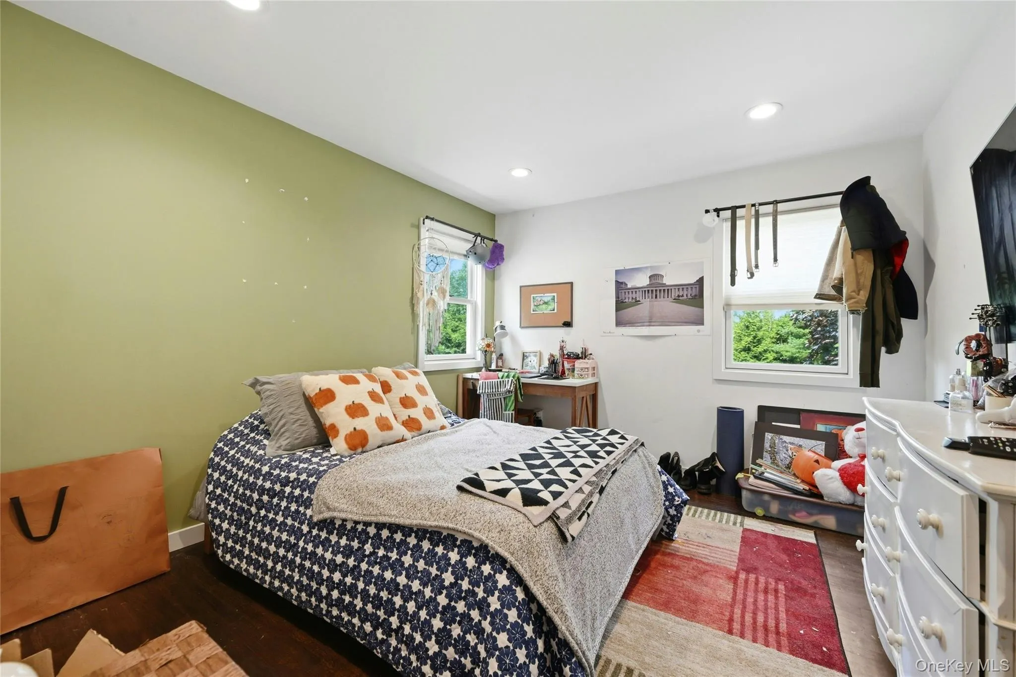 Secondary Bedroom featuring wood-finish flooring, recessed lighting, and two double-hung windows Secondary Bedroom featuring wood-finish flooring, recessed lighting, and two double-hung windows