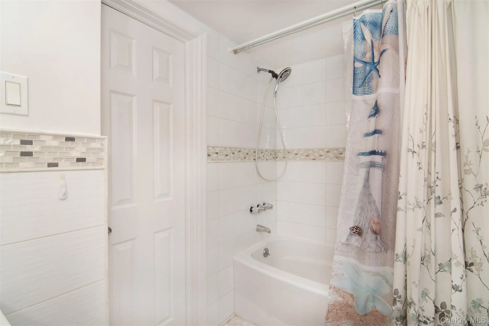 Bathroom featuring shower / tub combo Bathroom featuring shower / tub combo