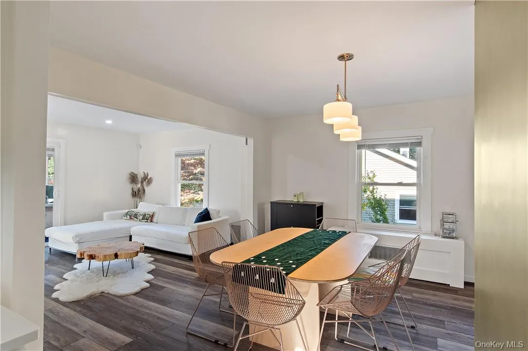 Dining area with dark hardwood / wood-style flooring and a wealth of natural light Dining area with dark hardwood / wood-style flooring and a wealth of natural light