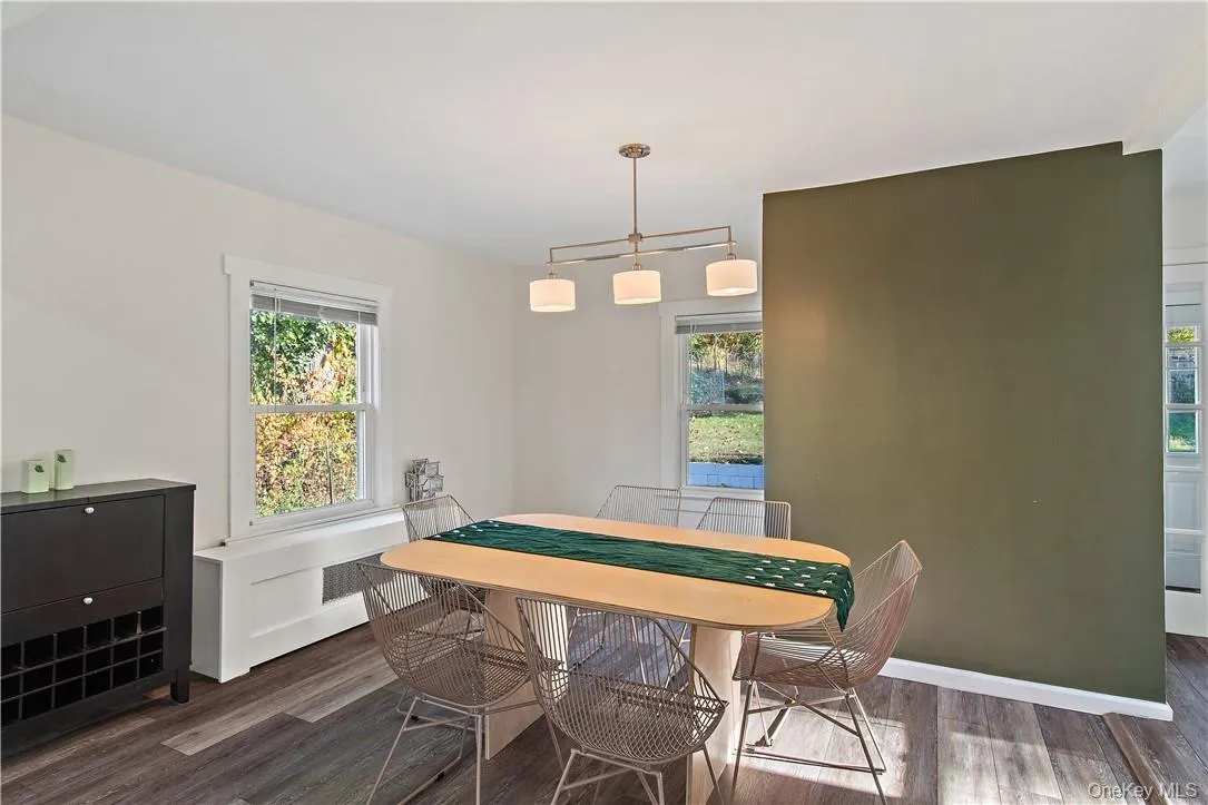 Dining space with dark hardwood / wood-style flooring Dining space with dark hardwood / wood-style flooring
