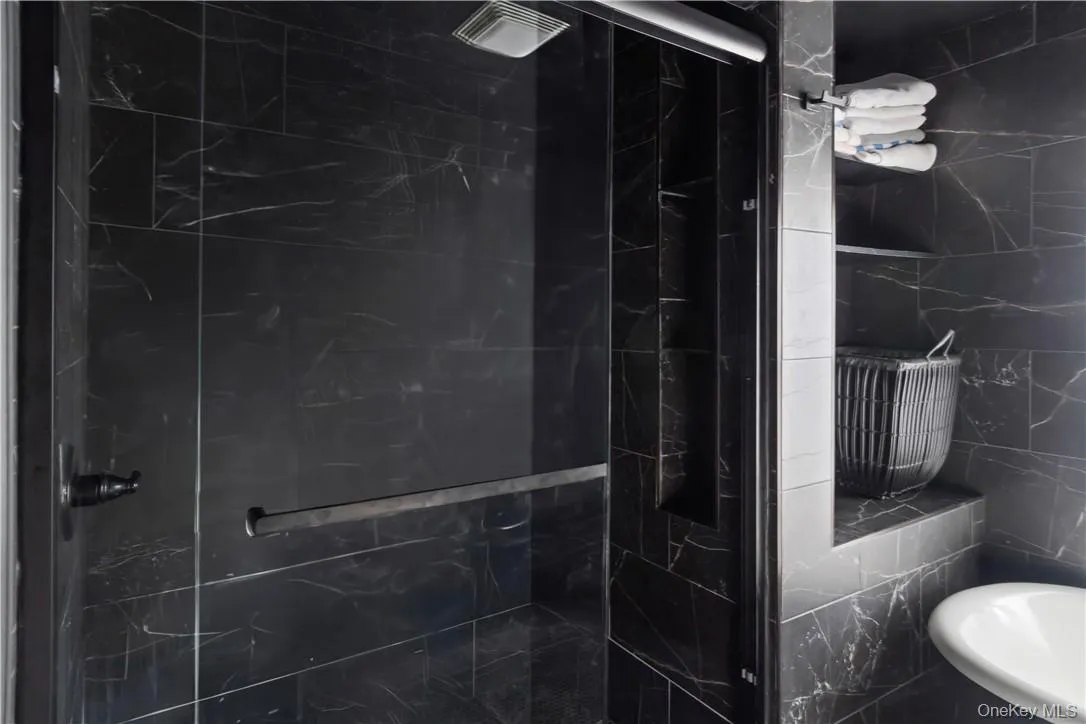2nd floor Bathroom featuring an enclosed shower and tile walls 2nd floor Bathroom featuring an enclosed shower and tile walls