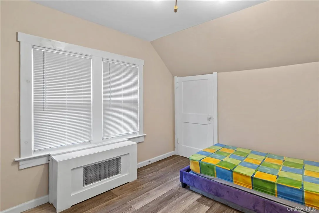 3rd bedroom featuring lofted ceiling and light hardwood / wood-style floors 3rd bedroom featuring lofted ceiling and light hardwood / wood-style floors