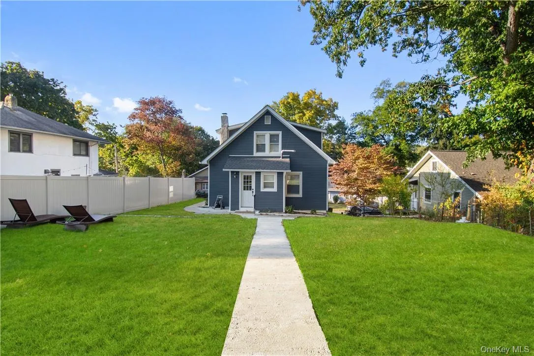 Back of property with a lawn Back of property with a lawn