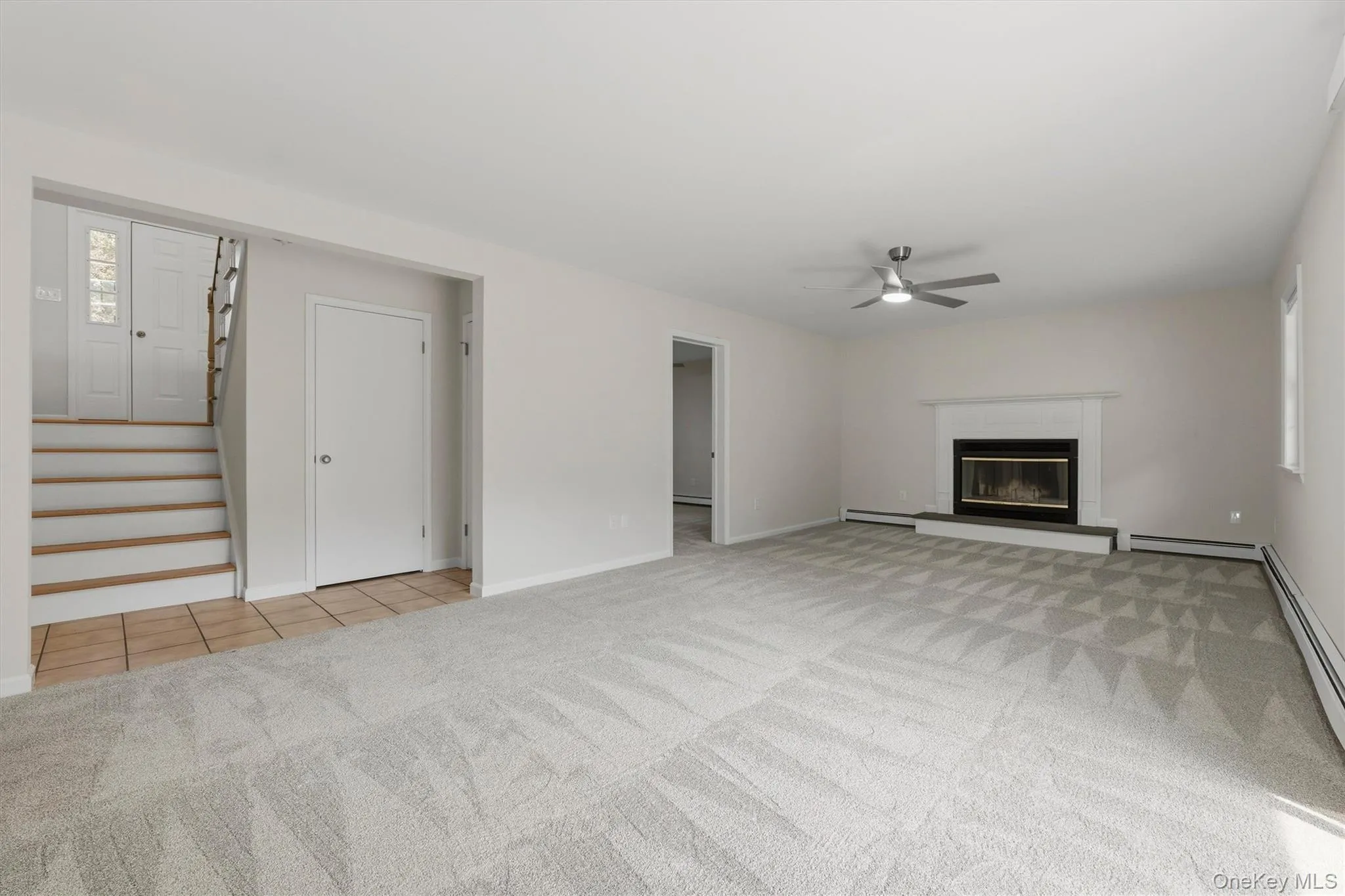 Lower Level Family Room with FP & Slider to Patio Lower Level Family Room with FP & Slider to Patio