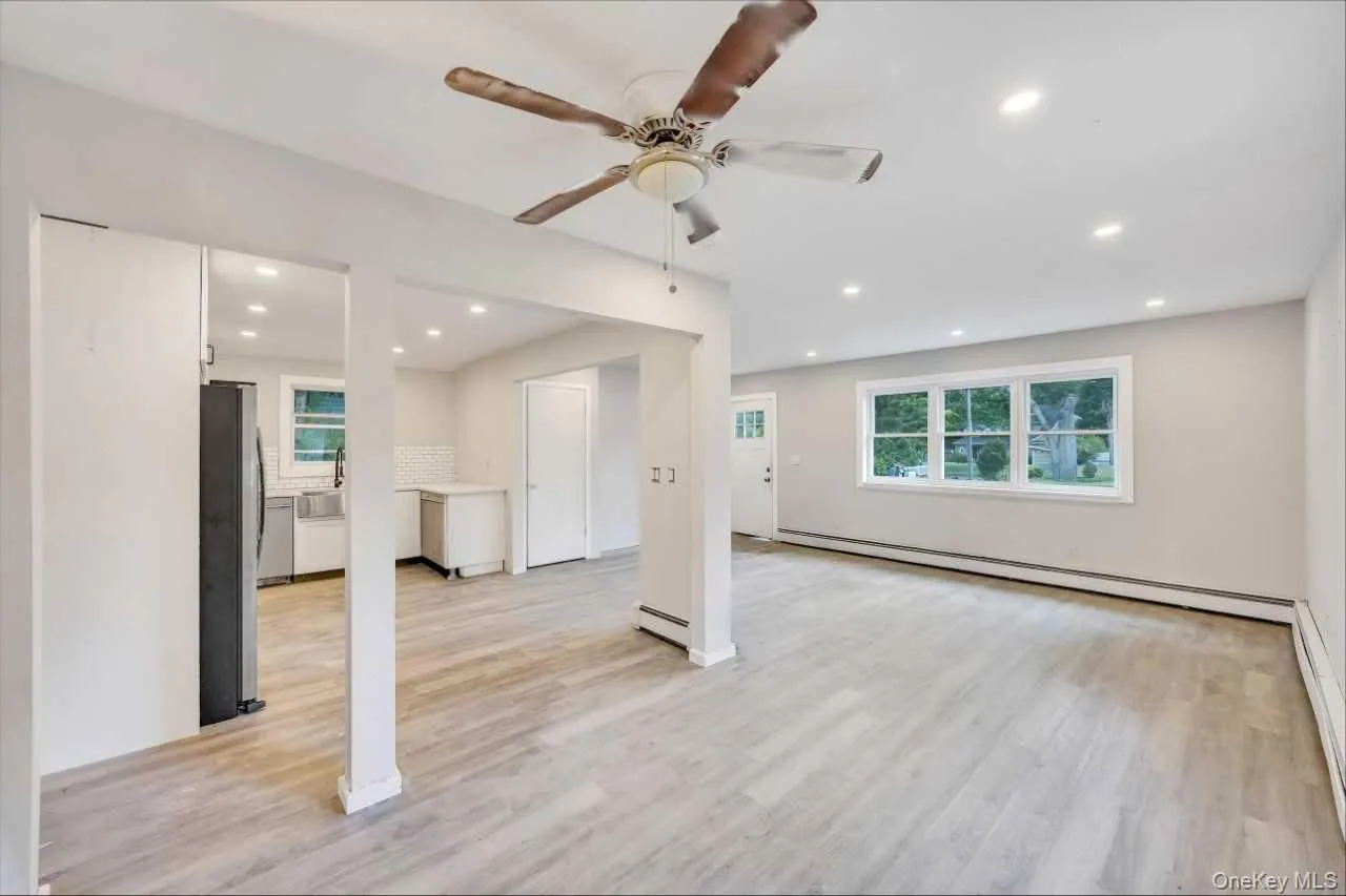 Bright interior space featuring light wood-finish flooring, recessed lighting, and a ceiling fan Bright interior space featuring light wood-finish flooring, recessed lighting, and a ceiling fan